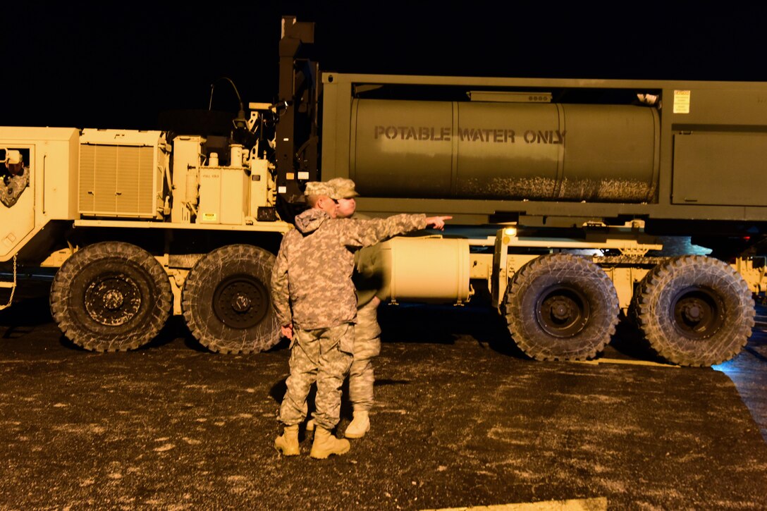 Army National Guardsmen discuss their plan to stage potable water tankers at an elementary school in High Ridge, Mo., Jan. 1, 2016. Missouri National Guard photo