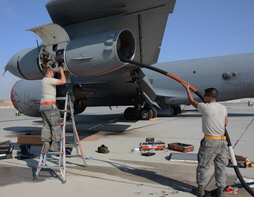 Senior Airman Reid Nixon (left), 340th Expeditionary Aircraft Maintenance Unit hydraulics journeyman from Odenton, Maryland and Senior Airman Michael Velazquez (right), 340 EAMU hydraulics journeyman from Rochester, New York, join a small team of hydraulics specialists as they install a multi-purpose refueling system on a KC-135 Stratotanker at Al Udeid Air Base, Qatar, Dec. 30, 2015. The system allows the aircraft to refuel any plane supporting Operation Inherent Resolve. (U.S. Air Force photo by Tech. Sgt. James Hodgman/Released)