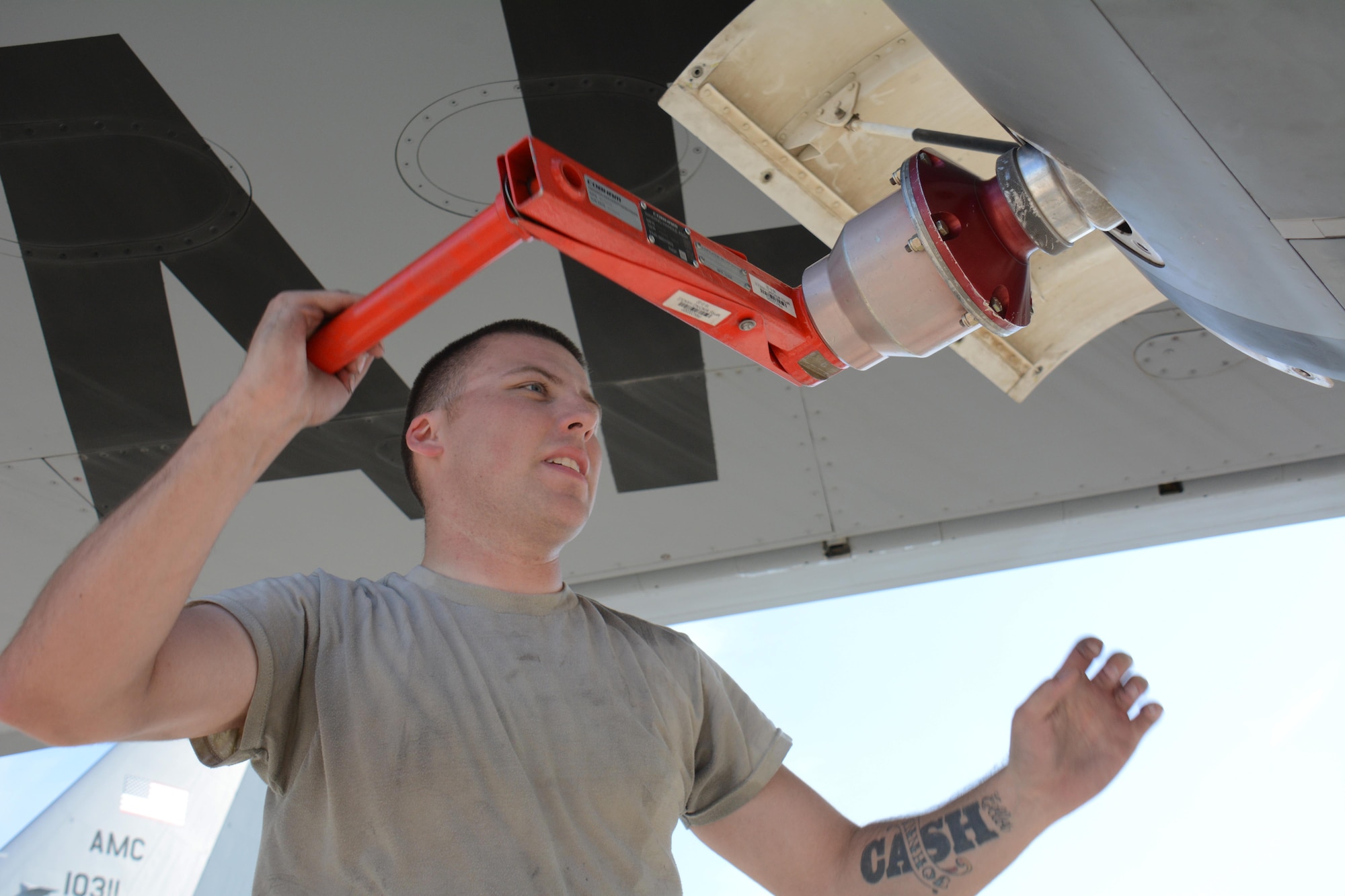 Senior Airman Reid Nixon, 340th Expeditionary Aircraft Maintenance Unit hydraulics journeyman from Odenton, Maryland, winds out a multi-purpose refueling system hose and basket with a MPRS winding handle after installing the system on a KC-135 Stratotanker at Al Udeid Air Base, Qatar, Dec. 30, 2015. The system allows the aircraft to refuel any plane supporting Operation Inherent Resolve. (U.S. Air Force photo by Tech. Sgt. James Hodgman/Released)