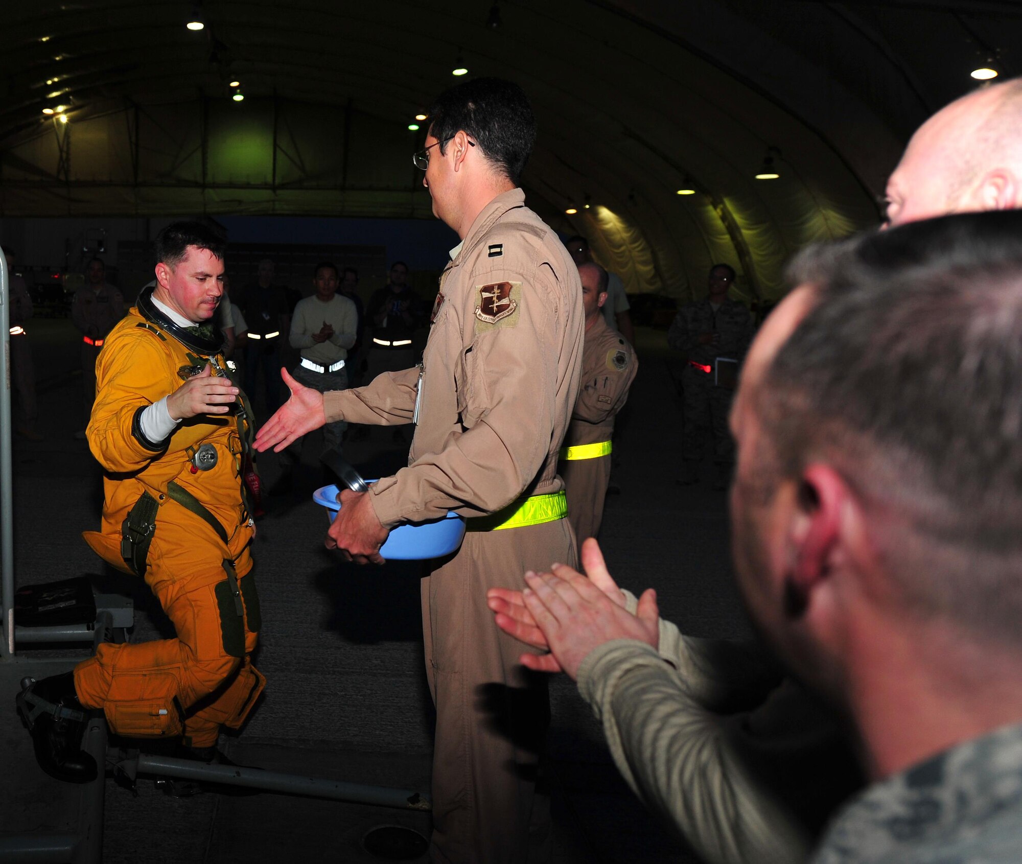 Capt. Stephen, 99th Expeditionary Reconnaissance Squadron operations officer and U-2 pilot, is welcomed back from a combat sortie by U-2 maintainers, physiological support technicians and fellow pilots at an undisclosed location in Southwest Asia, Dec. 7, 2015. At any one time there are hundreds of people supporting U-2 operations, from the maintainers on the ground to the intelligence personnel who analyze the information that is gathered and disseminated by U-2 pilots during combat sorties. (U.S. Air Force photo by Staff Sgt. Kentavist P. Brackin/released)