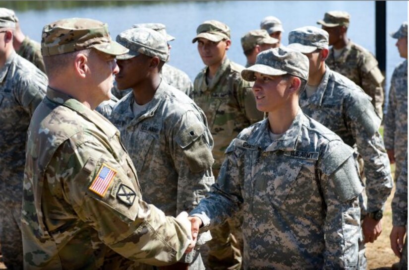 Maj. Gen. Scott Miller, commander, Maneuver Center of Excellence, shakes hands with Capt. Kristen M. Griest, one of the latest Soldiers to earn the Ranger tab on Fort Benning, Ga., Aug. 21, 2015.
