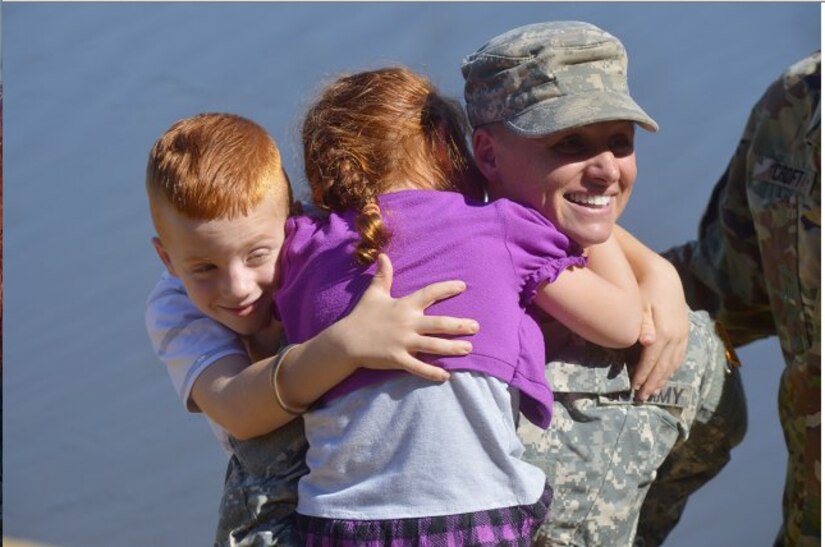 Maj. Lisa Jaster, a Reserve engineer officer in the Army Individual Mobilization Augmentee program, hugs her children after graduating from the Ranger course on Fort Benning, Ga., Oct. 16, 2015. Jaster is the third female, and the first female Reservist to win the prestigious recognition.