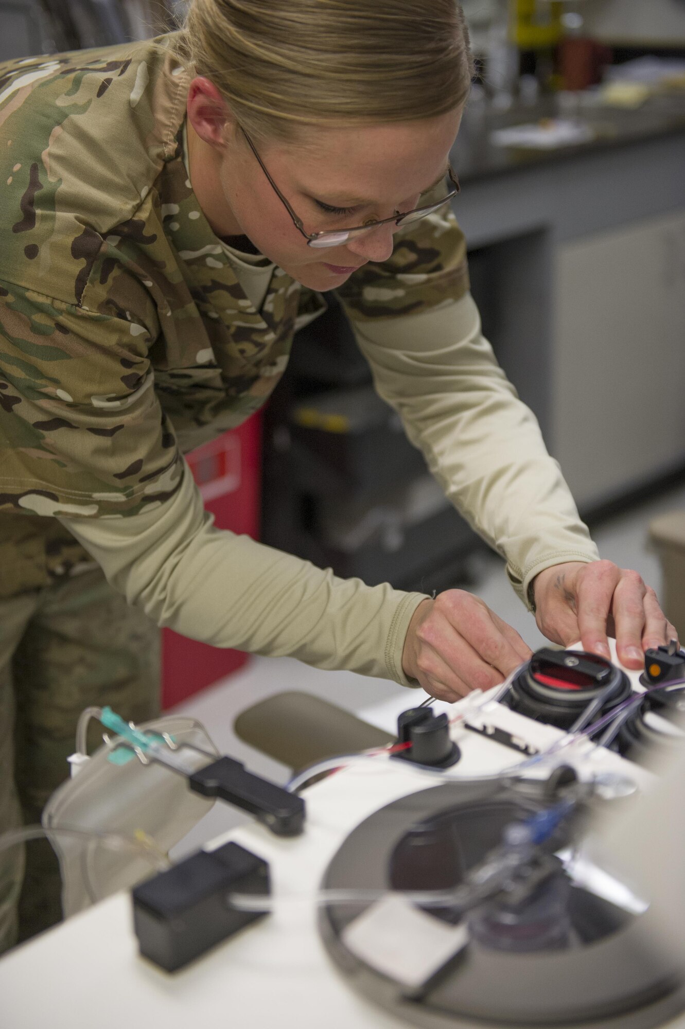 Spc. Lauren O'Neal, 153rd Blood Support Detachment medical laboratory technician, sets up an apheresis machine at Craig Joint Theater Hospital on Bagram Airfield, Afghanistan, Dec. 31, 2015. In order to extract platelets, a critical life-saving blood component, apherisis machines are used to draw blood and return the unused portions to the donor. (U.S. Air Force photo/Tech. Sgt. Robert Cloys)
