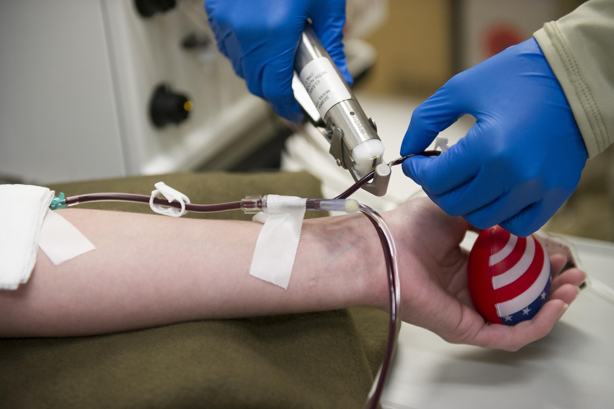 Spc. Lauren O'Neal, 153rd Blood Support Detachment medical laboratory technician, uses a hemosealer to seal blood bag tubing attached to a platelet donor at Craig Joint Theater Hospital on Bagram Airfield, Afghanistan, Dec. 31, 2015. In order to extract platelets, a critical life-saving blood component, blood is drawn using an apheresis machine which separates and returns the unused portions of blood to the donor. (U.S. Air Force photo/Tech. Sgt. Robert Cloys)