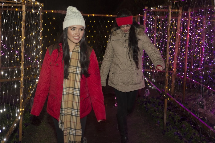 Michelle Vazquez, left, and Haily Galarza, program assistants with the Youth and Teen Center at Marine Corps Air Station Iwakuni walk through the maze of light at the Hiroshima Botanical Garden in Hiroshima City, Japan, Dec. 23, 2015. Residents watched as thousands of lights turned on and transformed the garden into a luminous display.