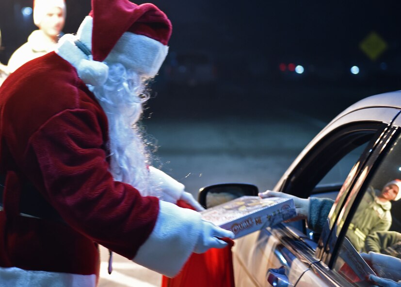 Santa Claus collects toys from personnel entering the base via the main gate during the December Unit Training Assembly here, Dec. 6, 2015. Toy donations benefitted the Marine Corps Reserve Toys for Tots campaign which provides toys for local children during the Christmas season. (U.S. Air Force photo/Tech. Sgt. Rick Lisum)