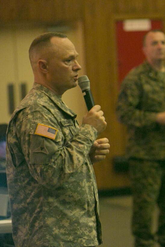 U.S. Army Chief Warrant Officer 4 Clifford W. Bauman gives a presentation on suicide prevention to Marines and sailors with the 2nd Marine Logistics Group at the base theater at Camp Lejeune, N.C., Dec. 15, 2015. The 2nd MLG conducted the presentation in order to create a command climate of prevention of suicides, suicide attempts and ideations through education and guided discussion. With an estimated national average of 22 veteran suicides a day, these briefs are designed to raise awareness among members of the military. (U.S. Marine Corps photo by Lance Cpl. Damarko Bones/released)