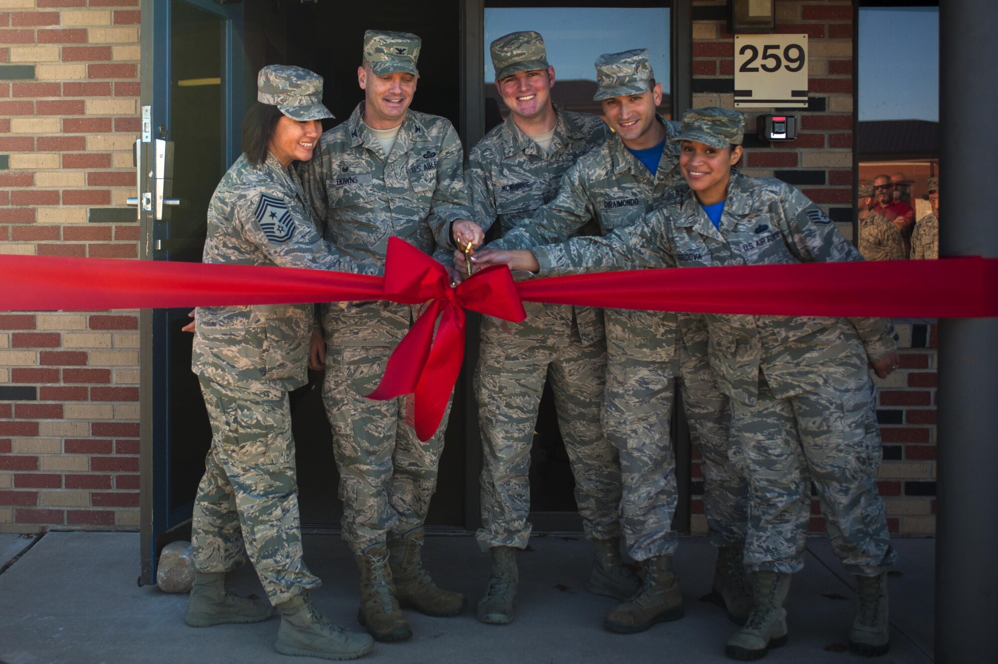 Base leadership Command Chief Master Sgt. JoAnne S. Bass, 17th Training Wing Command Chief, Col. Michael L. Downs, 17th Training Wing Commander, an Airman Committed to Excellence member and housing office members cut the ribbon on the Avenger’s Lounge during the opening ceremony on Goodfellow Air Force Base, Texas, Dec. 18, 2015. The Avenger’s Lounge is a new facility for permanent party members to hang out, relax and to call their own. The decision to make the Avenger’s Lounge came from the junior enlisted Airmen who worked with Command Chief Master Sgt. JoAnne S. Bass, 17th Training Wing Command Chief, and the dorm housing office. (U.S. Air Force photo by Senior Airman Scott Jackson/released)