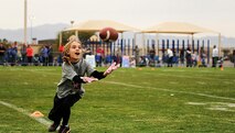 Jillian Artiges, daughter of Maj. Michael Artiges, 308th Fighter Squadron assistant director of operations, catches a pass during a youth football camp at Luke Air Force Base, Ariz., Jan. 29, 2015. The camp ran by ProCamps Worldwide, specialized in football fundamentals, with campers receiving instruction from NFL players and football coaches from the local area. 

