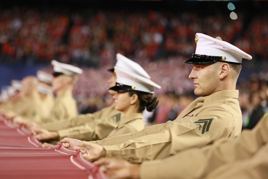 Marines hold the Big Flag at Qualcomm Stadium at San Diego, Calif, during the pre-game show at the 38th annual Holiday Bowl, Dec. 30, 2015. The flag, weighing 850 pounds, spans the entire field and requires a minimum of 250 people to support it while unfurled. The Marines are with I Marine Expeditionary Force at Marine Corps Base Camp Pendleton and Marine Corps Air Station Miramar. The University of Wisconsin Badgers emerged victorious over the University of Southern California Trojans with a final score of 23-21. (U.S. Marine Corps photo by Lance Cpl. Timothy Valero)