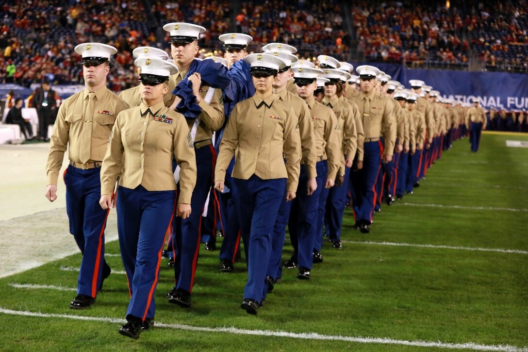 Approximately 250 Marines carry the Big Flag onto the field of Qualcomm Stadium at San Diego, Calif., during the pre-game show of the 38th annual Holiday Bowl, Dec. 30, 2015. The flag weighs 850 pounds and spans the entire field. The Marines are with I Marine Expeditionary Force at Marine Corps Base Camp Pendleton and Marine Corps Air Station Miramar. The University of Wisconsin Badgers emerged victorious over the University of Southern California Trojans with a final score of 23-21. (U.S. Marine Corps photo by Lance Cpl. Timothy Valero)