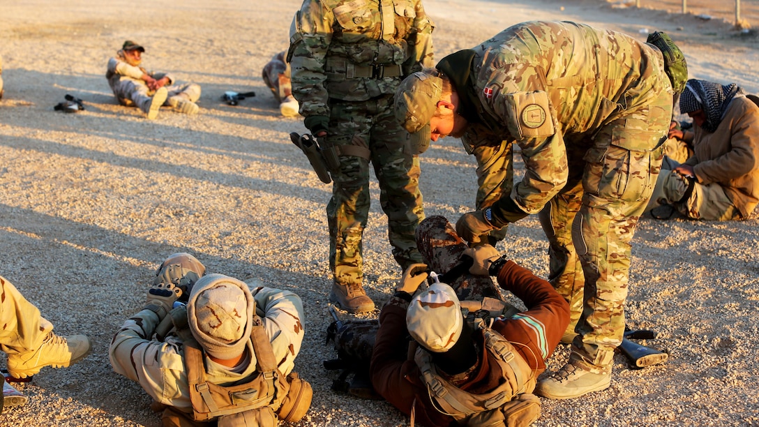 Members of the Royal Danish Army, attached to Task Force Al Asad, instruct Iraqi Security Forces in the proper way to apply a tourniquet during a combat life saver course at Al Asad Air Base, Iraq, Dec. 29, 2015.  The task force has trained approximately 2,700 Iraqi soldiers with the 7th Iraqi Army Division through the building partner capacity program. By enabling Iraqi Security Forces through advise and assist, and building partner capacity missions, the Combined Joint Task Force – Operation Inherent Resolve’s multinational coalition is helping the Government of Iraq to set the conditions to defeat the Islamic State of Iraq and the Levant.