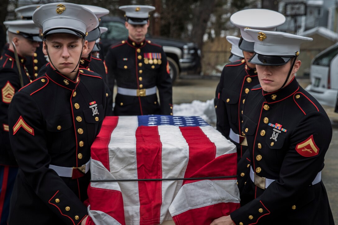 New Marines on recruiters assistance with Recruiting Substation Brockton, Massachusetts, carry the casket of Sam Bernstein, a former Marine who fought on Iwo Jima, into the Temple Beth AM prior to his burial, Dec. 30. Bernstein left the Marine Corps as a corporal following his return from Japan, but never forgot his time in service.