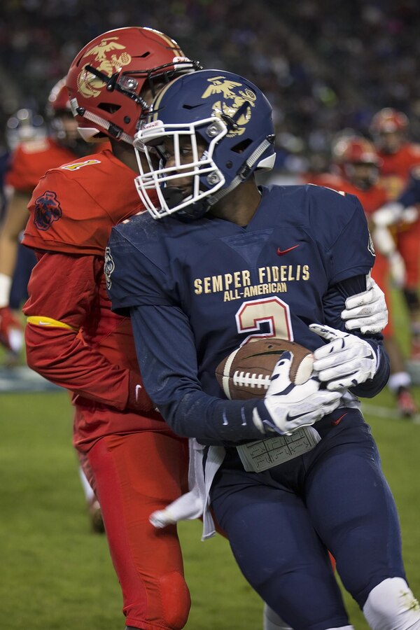 Isaiah Graham is blocked by Parrish Cobb during the Semper Fidelis All-American Bowl at the Stubhub Center, Carson, Calif., Jan. 3, 2016. High school athletes chosen to play in the Semper Fidelis All-American Bowl are well-rounded individuals on and off the field who not only are distinguished athletes, but also have academic achievements and display exemplary moral character. Graham is wide receiver from Bastrop High School, Bastrop, La., and Cobb is a cornerback from La Vega High School, Waco, Texas. (U.S. Marine Corps photo by Sgt. Rebecca Eller)