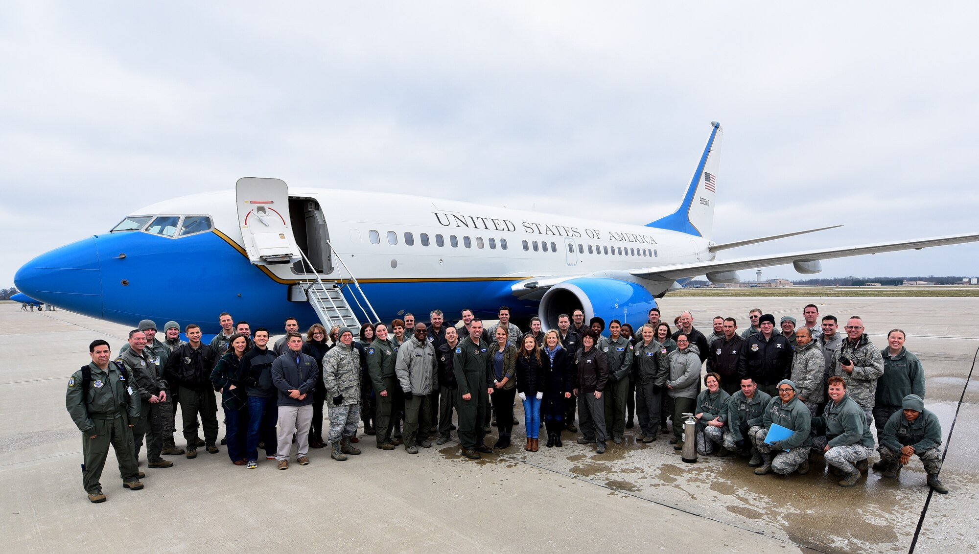 Col. Karl Goerke, 932nd Airlift Wing commander, center, stands with his family, friends and fellow 932nd Airlift Wing Airmen after completing his final flight aboard the unit's C-40C, also called the fini flight.  Military aviators have a tradition where aircrew members, upon completion of their very last final flight, or fini flight are met and hosed down with water by their squadron comrades, family, and friends.  (U.S. Air Force photo by Christopher Parr)