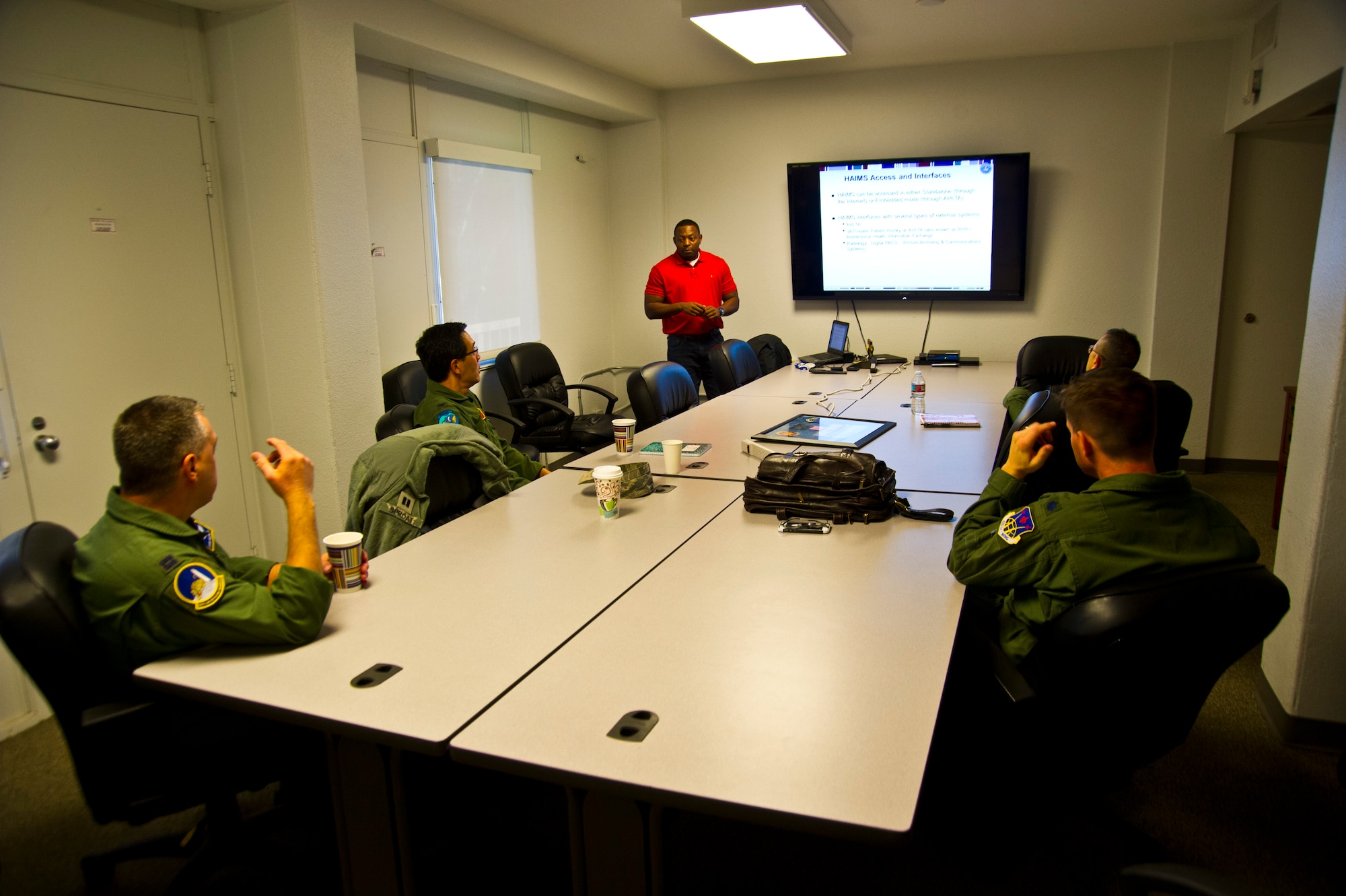 NELLIS AIR FORCE BASE, Nev. -- (Standing) Mr. Negarren Colbert, a medical systems contractor with Air Force Reserve Command, trains 926th Aerospace Medical Squadron personnel on the Joint Legacy Viewer and Health Artifacts Image Management Solution systems here Dec. 5 in preparation for the unit's transition to electronic records. (U.S. Air Force photo/Senior Airman Brett Clashman)