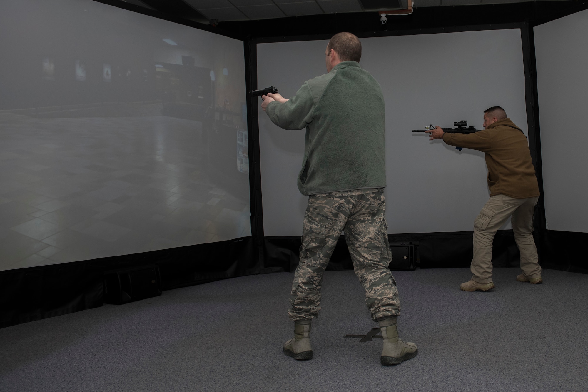 PETERSON AIR FORCE BASE, Colo. – Col. Doug Schiess, 21st Space Wing commander, goes through a virtual training session with Isaac Lopez, 21st Security Forces Squadron, during his tour of the 21st SFS Training Complex on Dec. 17, 2015. Schiess also discussed 21st SFS mission and needs during his visit, toured the base armory, visited logistics to see their resources and visited plans and programs. (U.S. Air Force photo by Senior Airman Rose Gudex)