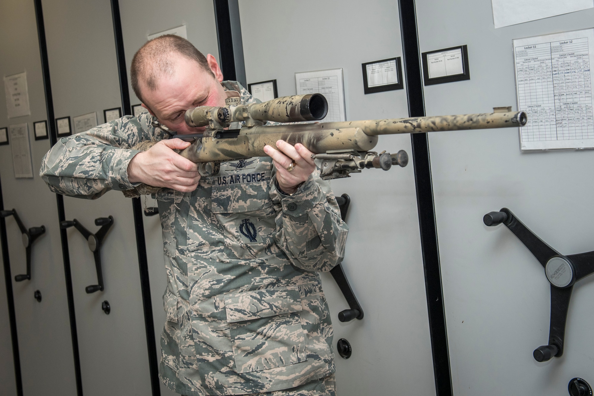 PETERSON AIR FORCE BASE, Colo. – Col. Doug Schiess, 21st Space Wing commander, looks down the scope of an M24 sniper rifle during a tour of the armory Dec. 17, 2015 at Peterson Air Force Base. In addition to the armory, he discussed mission requirements and challenges before touring the training complex and visiting with the plans and programs department of the 21st Security Forces Squadron. (U.S. Air Force photo by Senior Airman Rose Gudex)