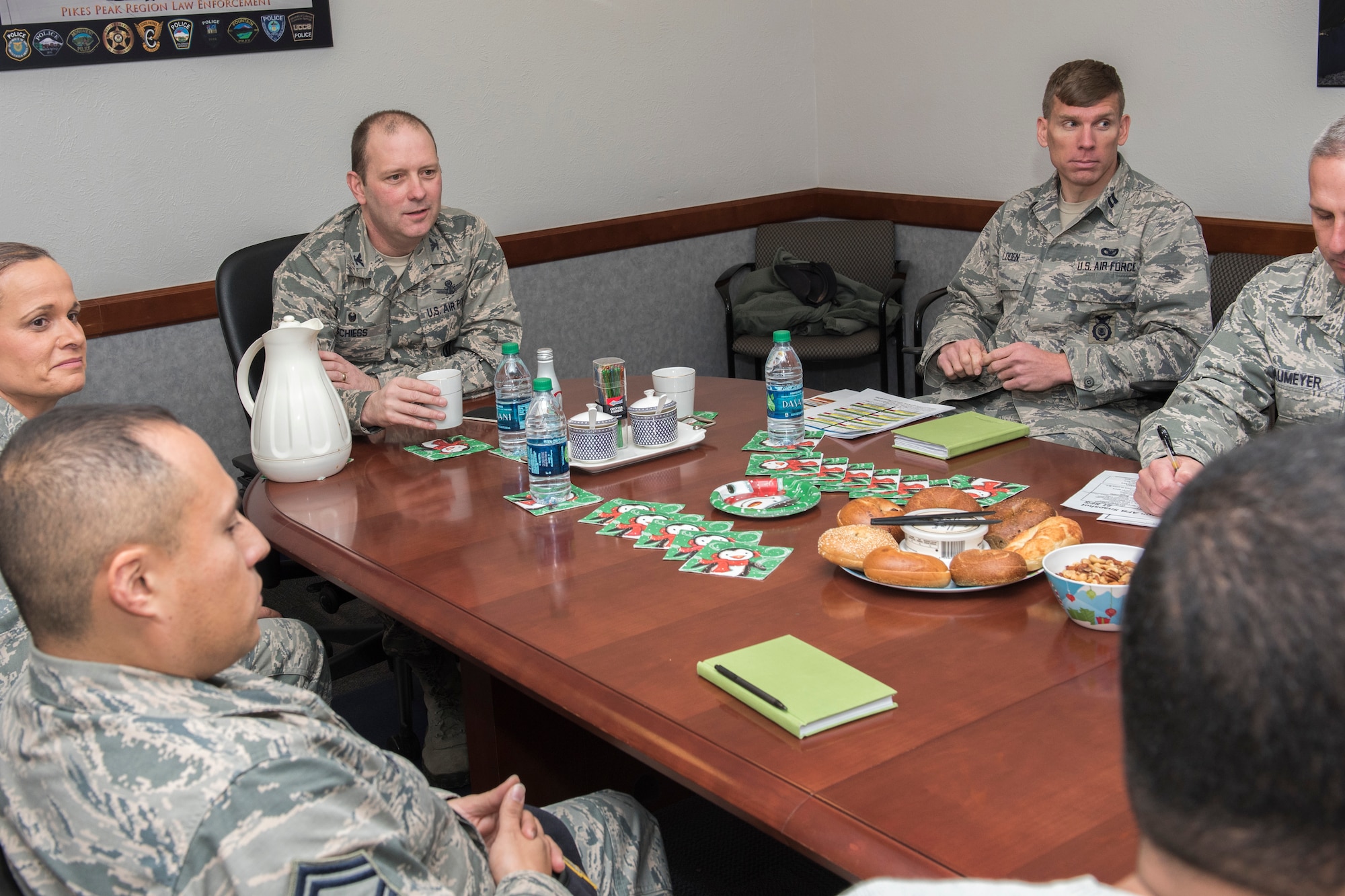 PETERSON AIR FORCE BASE, Colo. – Col. Doug Schiess, 21st Space Wing commander, visits with Airmen from the 21st Security Forces Squadron to discuss mission needs and see how things work Dec. 17, 2015. He received a brief, toured the armory and spent time at the training center participating in much of the training the defenders receive. (U.S. Air Force photo by Senior Airman Rose Gudex)