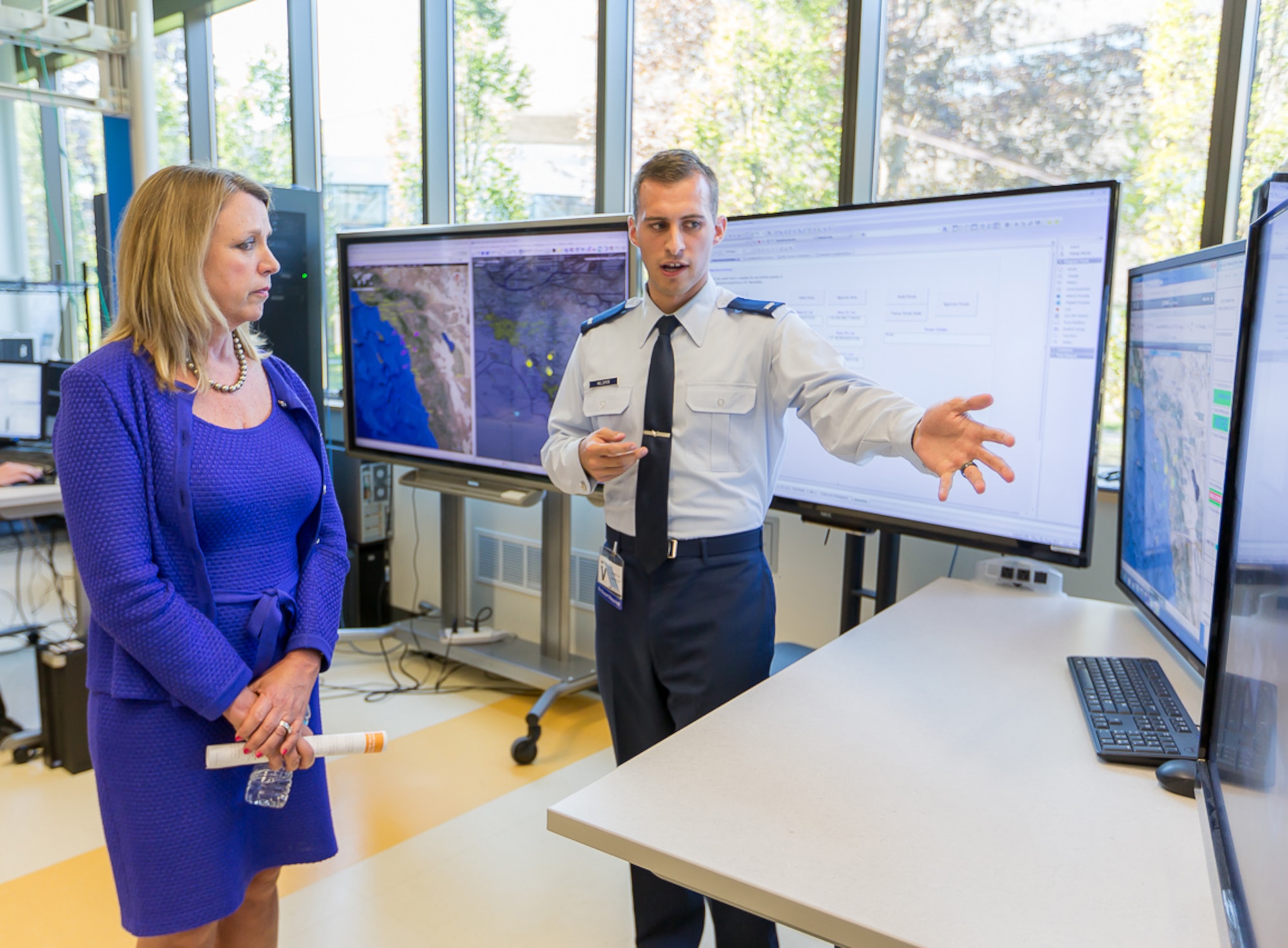 U.S. Air Force 1st Lt. Craig Helsper, BMC2 systems engineer, details the inner workings of the JSTARS battle management command and control system to Secretary of the Air Force Deborah Lee James during a site visit to MITRE in Bedford, Massachusetts, Aug. 20, 2015. The BMC2 system is one of four E-8C JSTARS components that is undergoing a major recapitalization. (Photo by Michael Baker)