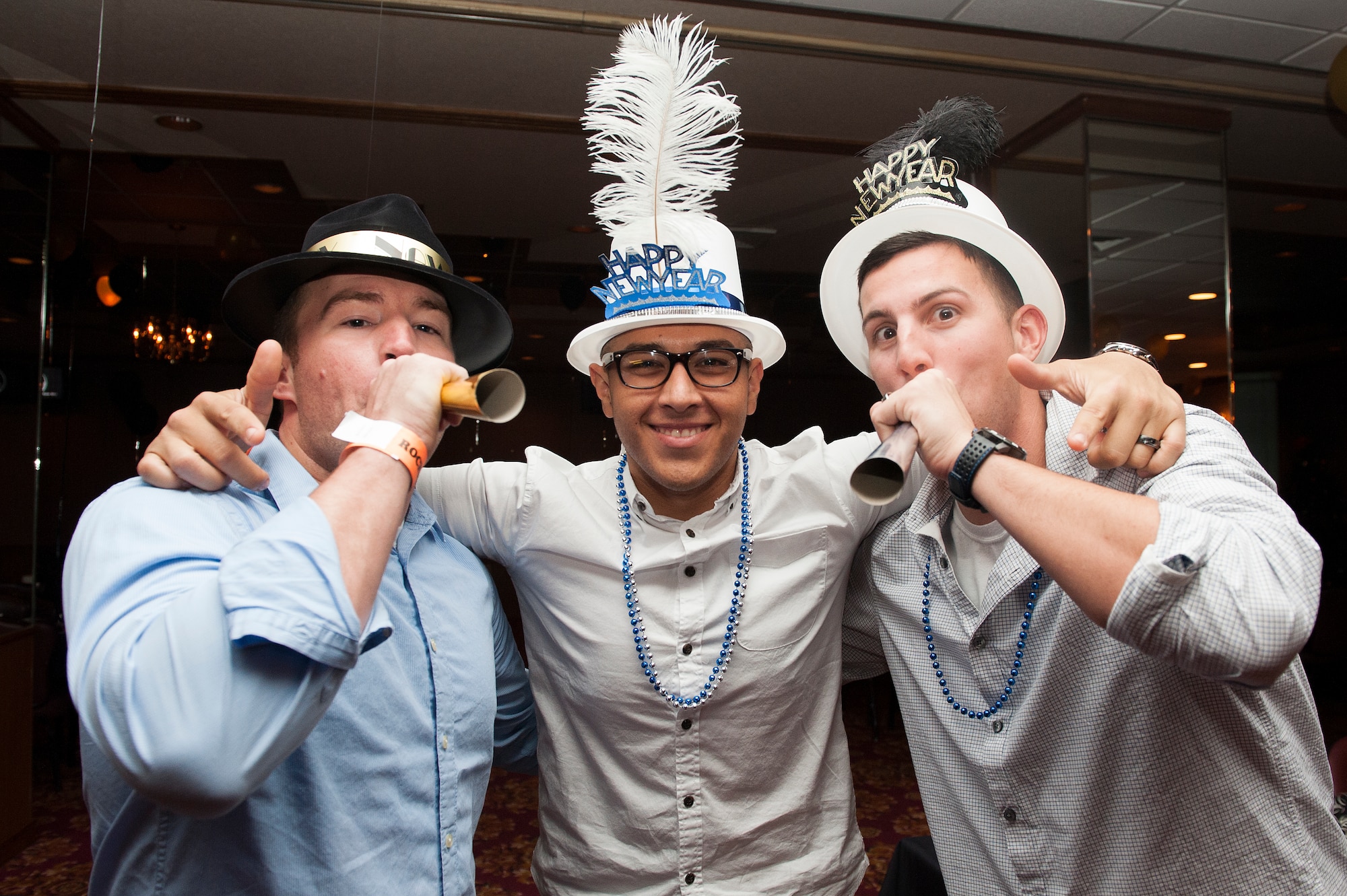 U.S. Air Force Senior Airmen Drew Kennett, Jacob Montiel and Ian Swartzwelder, 18th Aircraft Maintenance Squadron weapons load crew members, celebrate the new year at the Rocker NCO Club Dec. 31, 2015, at Kadena Air Base, Japan. The New Year’s Eve party was the final event held at the Rocker NCO Club before it closed its doors to make way for a brand new facility. (U.S. Air Force photo by Airman 1st Class Corey M. Pettis)