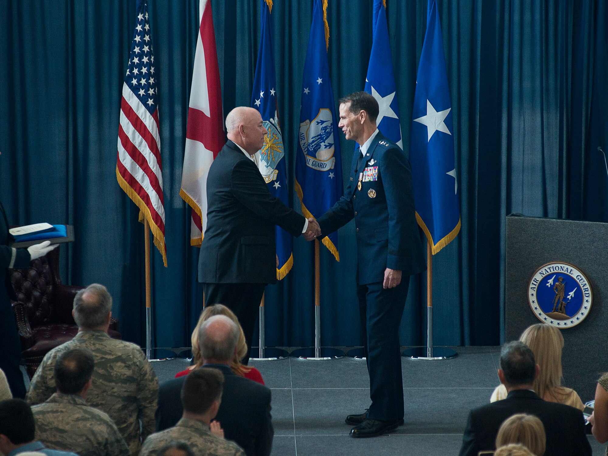 Retired General T. Michael Moseley, former Air Force chief of staff, and Lt. Gen. Stanley E. Clarke, III, Air National Guard director, exchange a handshake after Clarke is awarded the Legion of Merit during Clarke's retirement ceremony held at the Air National Guard Readiness Center on Joint Base Andrews, Md., December 18, 2015. Clarke is the 15th ANG director, and has served in that position since March, 2013. (U.S. Air National Guard photo by Staff Sgt. John E. Hillier/Released)