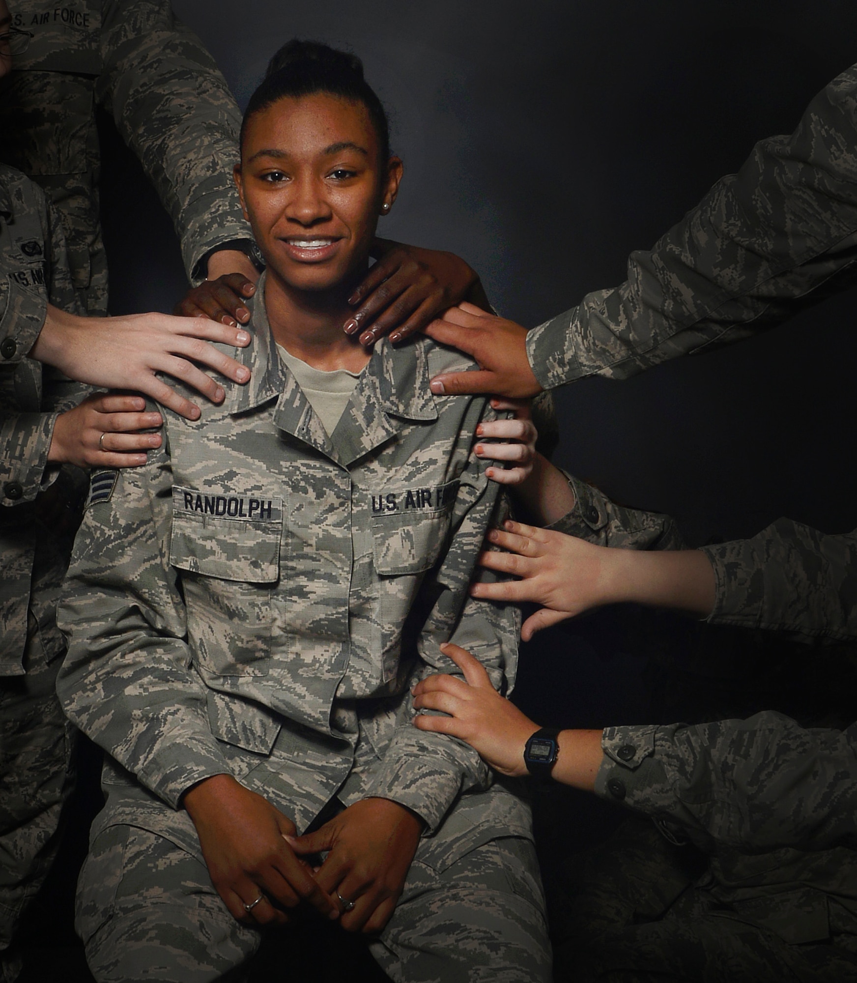 Members assigned to the 6th Air Mobility Wing public affairs office reaches out their hands to touch me Dec. 23, 2015 at MacDill Air Force Base, Fla. Their hands represent my military family having my back in the time of need and being my support system. (U.S. Air Force photo illustration by Senior Airman Jenay Randolph) 