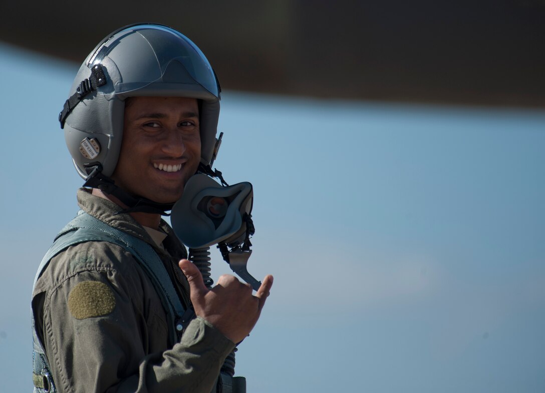 U.S. Air Force Staff Sgt. Ariful Haque, 7th Civil Engineer Squadron water and fuels craftsman, shows his excitement while waiting to board a B-1B Lancer Nov. 20, 2015, at Dyess Air Force Base, Texas. Haque was one of two Airmen selected to fly as a passenger as part of an incentive program rewarding superior-performing Airmen for the month of November. (U.S. Air Force photo by Airman Quay Drawdy/Released)
