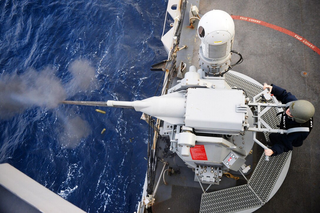 U.S. Navy Petty Officer 2nd Class Stephanie Drake fires a Mark 38 25 mm machine gun during a live-fire exercise on the USS Carney in the Mediterranean Sea, Dec. 31, 2015. The Carney is conducting a routine patrol in the U.S. 6th Fleet area of responsibility to support U.S. national security interests in Europe. U.S. Navy photo by Petty Officer 1st Class Theron J. Godbold
