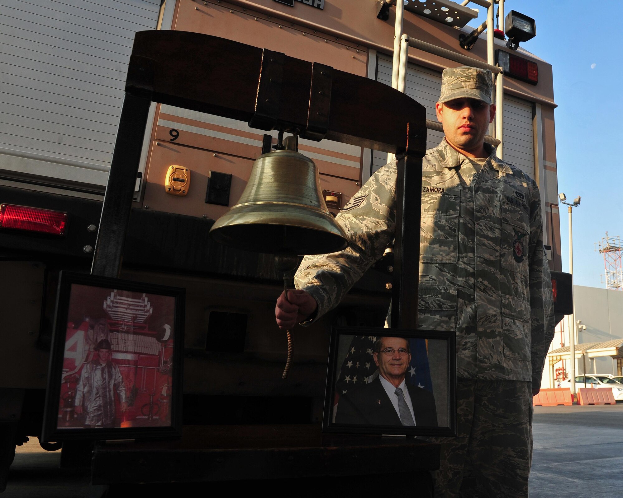 Staff Sgt. Hector, 380th Expeditionary Civil Engineer Squadron firefighter, rings a bell during a Firefighter Last Call Ceremony for departed, former Air Force Fire Chief Donald Warner at an undisclosed location in Southwest Asia, Dec. 30, 2015. The belling ringing, recalls a time in history when its sounding was intertwined with the lives of firefighters, the ringing calling firefighters to an alarm and another signaling the alarm was over. (U.S. Air Force photo by Staff Sgt. Kentavist P. Brackin/released)