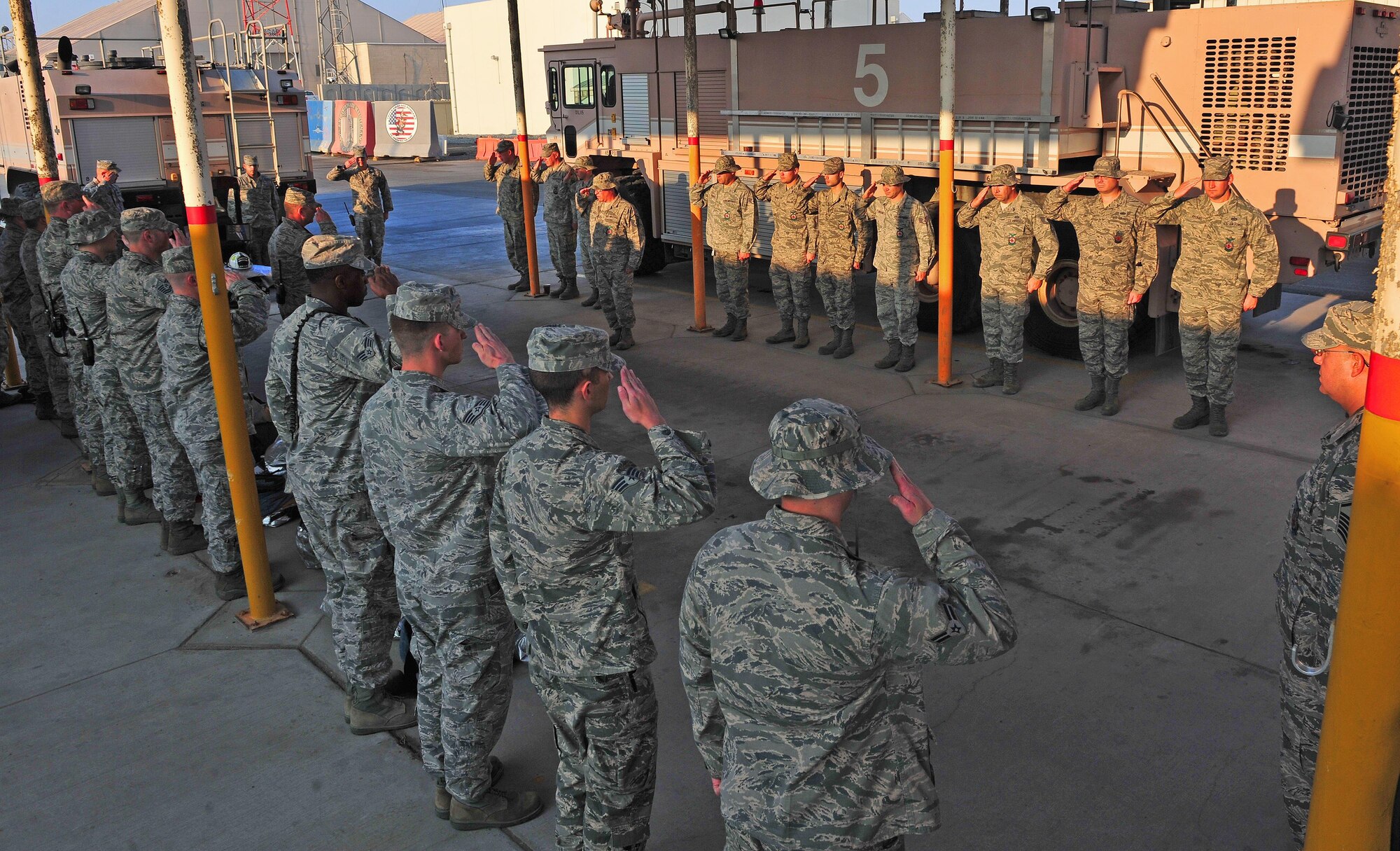 Firefighters from the 380th Expeditionary Civil Engineer Squadron Fire Department render a salute during a Firefighter Last Call Ceremony for departed, former Air Force Fire Chief Donald Warner at an undisclosed location in Southwest Asia, Dec. 30, 2015. Among Warner’s contributions to Air Force firefighting include coining the Air Force fire protection motto “The Desire to Serve, the ability to Perform, and the Courage to Act,” and successful pushing to have fallen DOD firefighter’s names added to the National Fallen Firefighters Memorial in Emmetsburg, MD. (U.S. Air Force photo by Staff Sgt. Kentavist P. Brackin/released)
