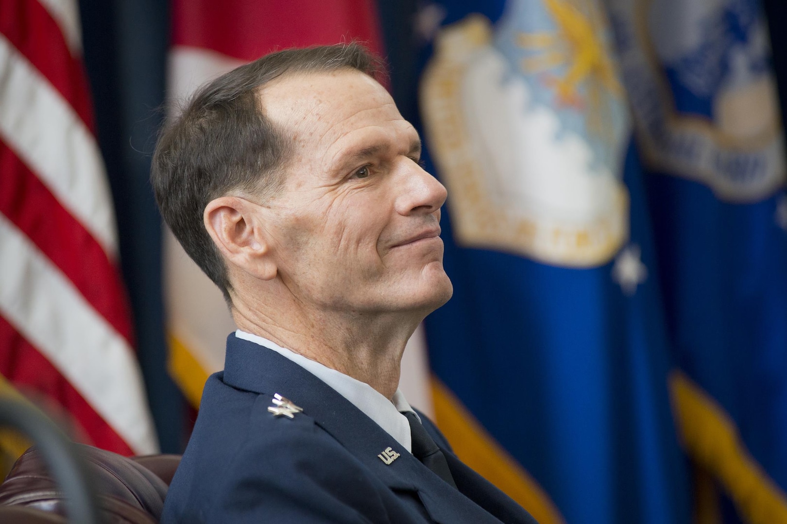 Lt. Gen. Stanley E. Clarke III listens while retired Air Force Chief of Staff Gen. T. Michael Moseley reflects on Clarke’s career during the former’s retirement ceremony at the Air National Guard Readiness Center, Joint Base Andrews, Maryland, Dec. 18, 2015. Clarke is the 15th director of the Air National Guard. 