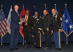 DLA director Air Force Lt. Gen. Andy Busch, left, presents Pearl Pearson, Jr., a packer assigned to the Preservation, Packaging, Packing and Marking Branch at Defense Logistics Agency Distribution Oklahoma City, Okla., with the 2015 Outstanding DLA Employee with a Disability Award  at the 48th annual employee recognition ceremony Dec. 10.  Distribution’s commander Army Brig. Gen. Richard Dix, third from right, DLA’s equal employment opportunity director Ferdinand LeCompte, second from right, and DLA’s Senior Enlisted Leader Army Command Sgt. Maj. Charles Tobin, right, were also on-hand to present the award.