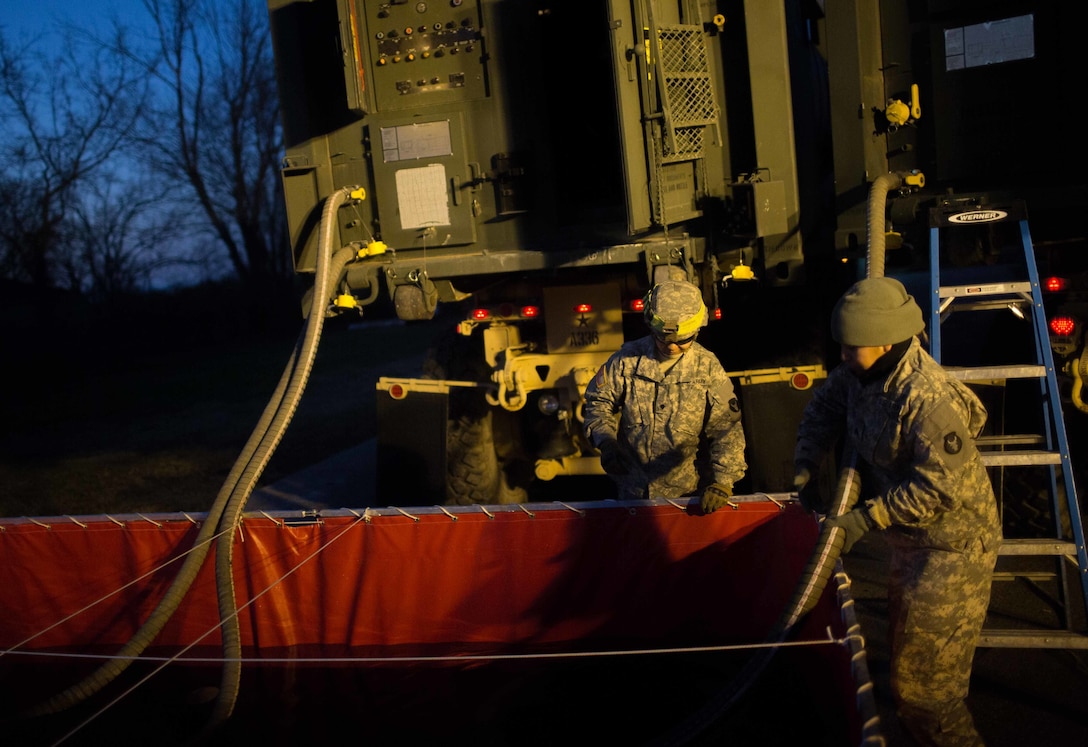 Soldiers assigned to the 334th Brigade Support Battalion, Iowa National Guard, conduct a water purification mission in High Ridge, Mo., Jan. 3, 2016. Soldiers and Airmen assigned to the Missouri National Guard volunteered to support the Missouri Department of Transportation in flood relief efforts in south central Missouri. The focus of the aid is to ensure traffic control, water purification and levee reinforcement in affected areas. U.S. Army photo by Cpl. Harold Flynn