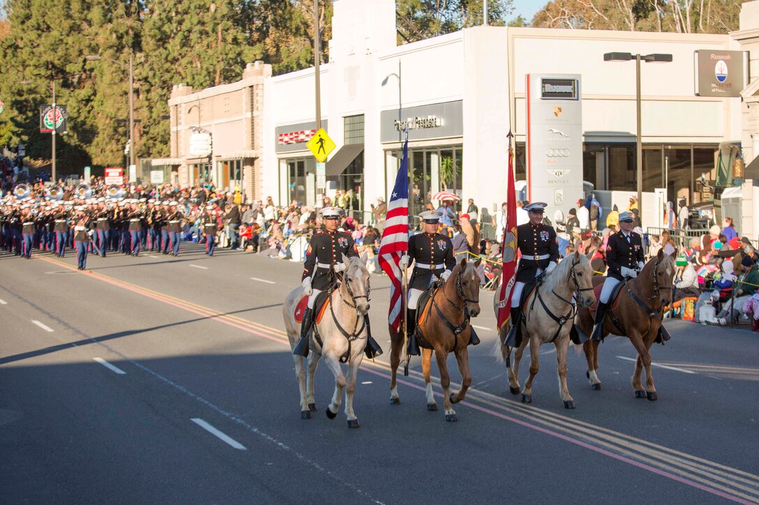 The Marine Corps Mounted Color Guard, from Marine Corps Logistics Base Barstow, leads the United States Marine Corps West Coast Composite Band, from San Diego, down Colorado Boulevard,Pasadena, Calif., during the 127th Tournament of Roses Parade, Jan. 1, 2016. 