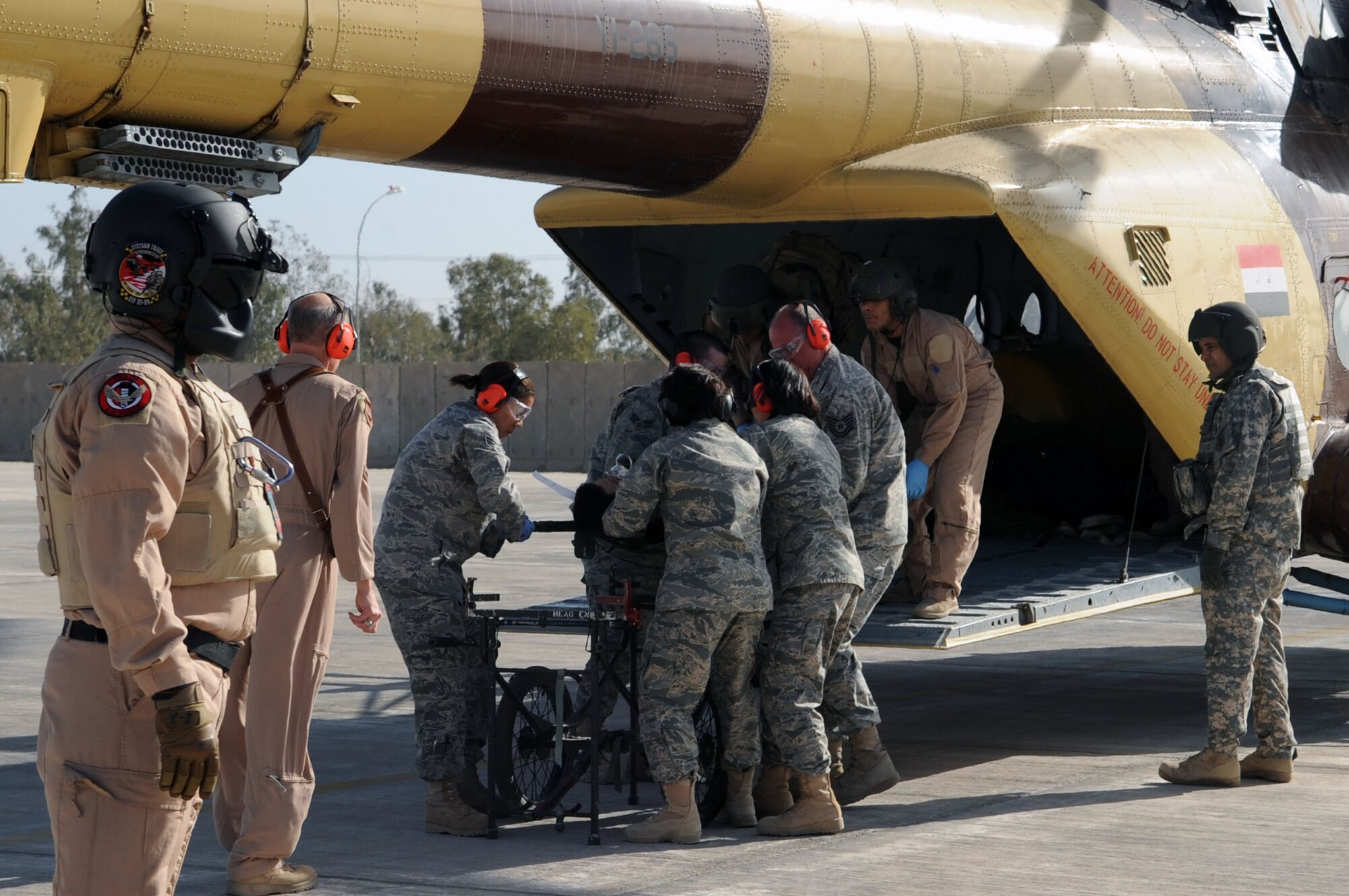 JOINT BASE BALAD, Iraq – Members of the 332nd Expeditionary Medical Group unload a patient from an Iraqi helicopter during medical evacuation training for the Iraqi Air Force Dec. 21, 2009. (U.S. Air Force photo/Senior Airman Brittany Y. Bateman)