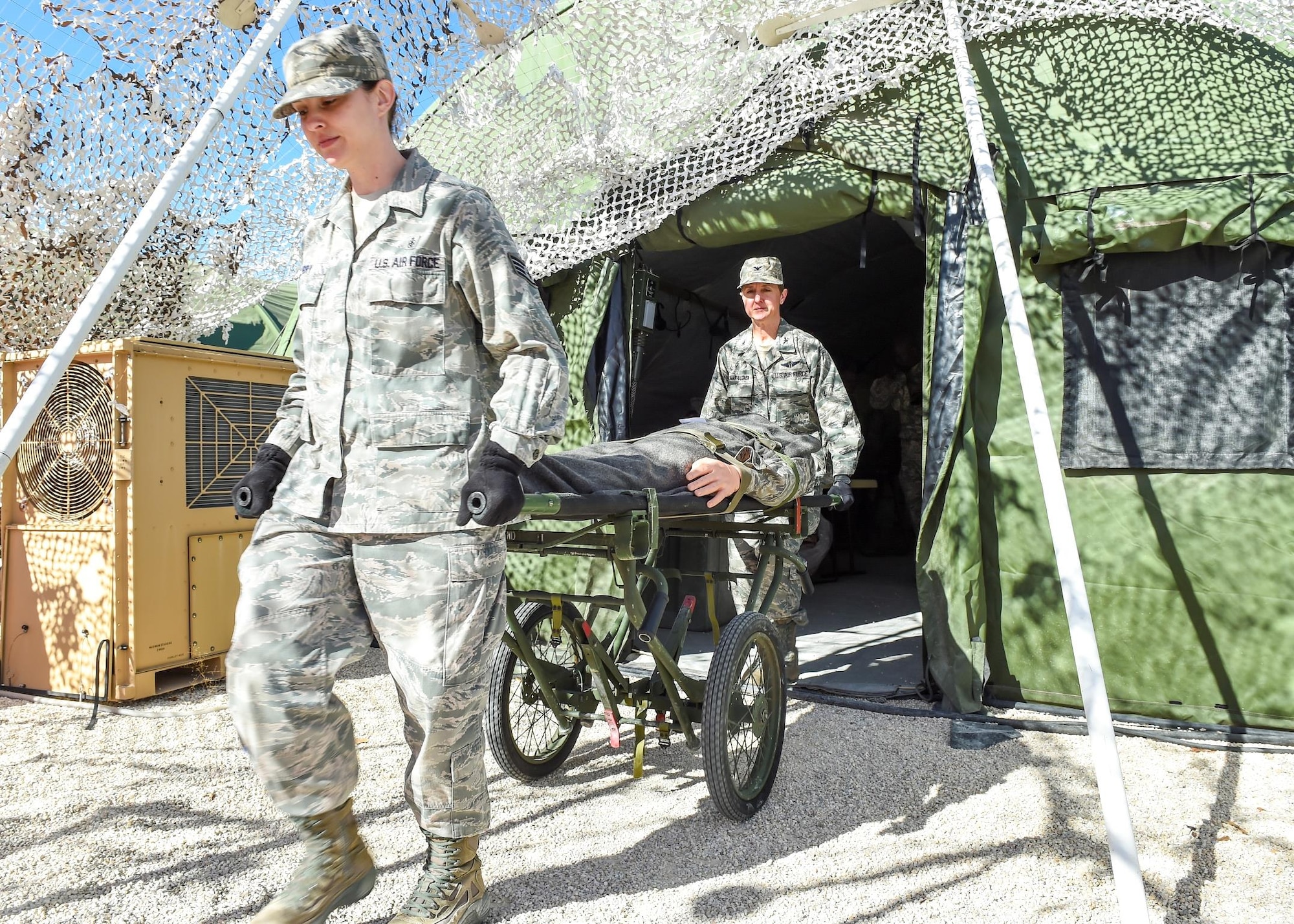 Air Force students carry a training mannequin during a Dec. 17, 2015, expeditionary medical support system exercise at Camp Bullis, Texas. The exercise tests a student’s ability to quickly respond to an emergency by providing care and evacuating casualties in a simulated deployed environment. Technical training students are assigned one of four squadrons in the 59th Training Group. The unit’s partnership with the Medical Education and Training Campus on Joint Base San Antonio-Fort Sam Houston, Texas, affords training for members of the five uniformed services and international students. The 59th TRG manages 125 acres at the Medical Readiness Training Center on Camp Bullis.