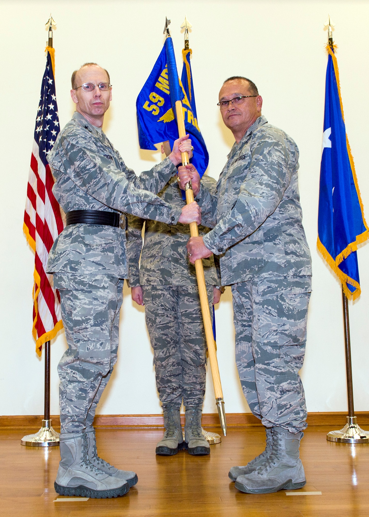 Maj. Gen. Bart Iddins, 59th Medical Wing commander, gives command of the 59th Training Group to Col. Steven Caberto during an activation ceremony Jan. 4, 2016, at JBSA-Fort Sam Houston, Texas. The 59th TRG supports military medical service and medical readiness training at the Medical Education and Training Campus for 12,100 students annually, and at two operating locations, one detachment and 17 sites around the world. 