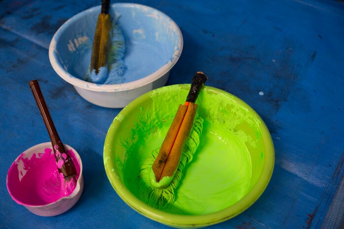 Members of the Calligraphy Club at Kannon High School, Hiroshima, used different paints and brushes during the demonstration at a calligraphy event with Marine Corps Air Station Iwakuni home-schoolers at Waki General Community Center, Waki Town, Japan, Jan. 4, 2016. Community relations events like these help bolster the relationship between the U.S. and Japan.