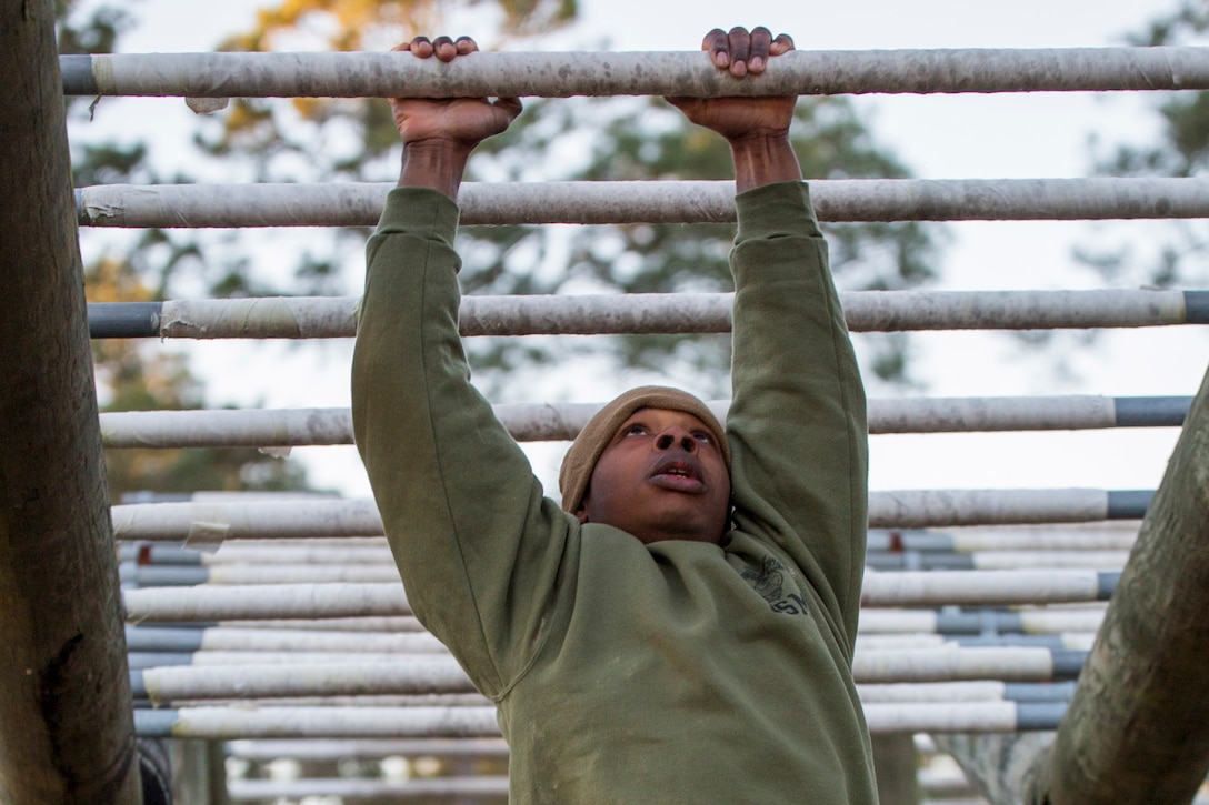 Marine Corps recruit Christopher D. Stone climbs a confidence course obstacle on Parris Island, S.C., Jan. 5, 2016. Marine Corps photo by Sgt. Jennifer Schubert