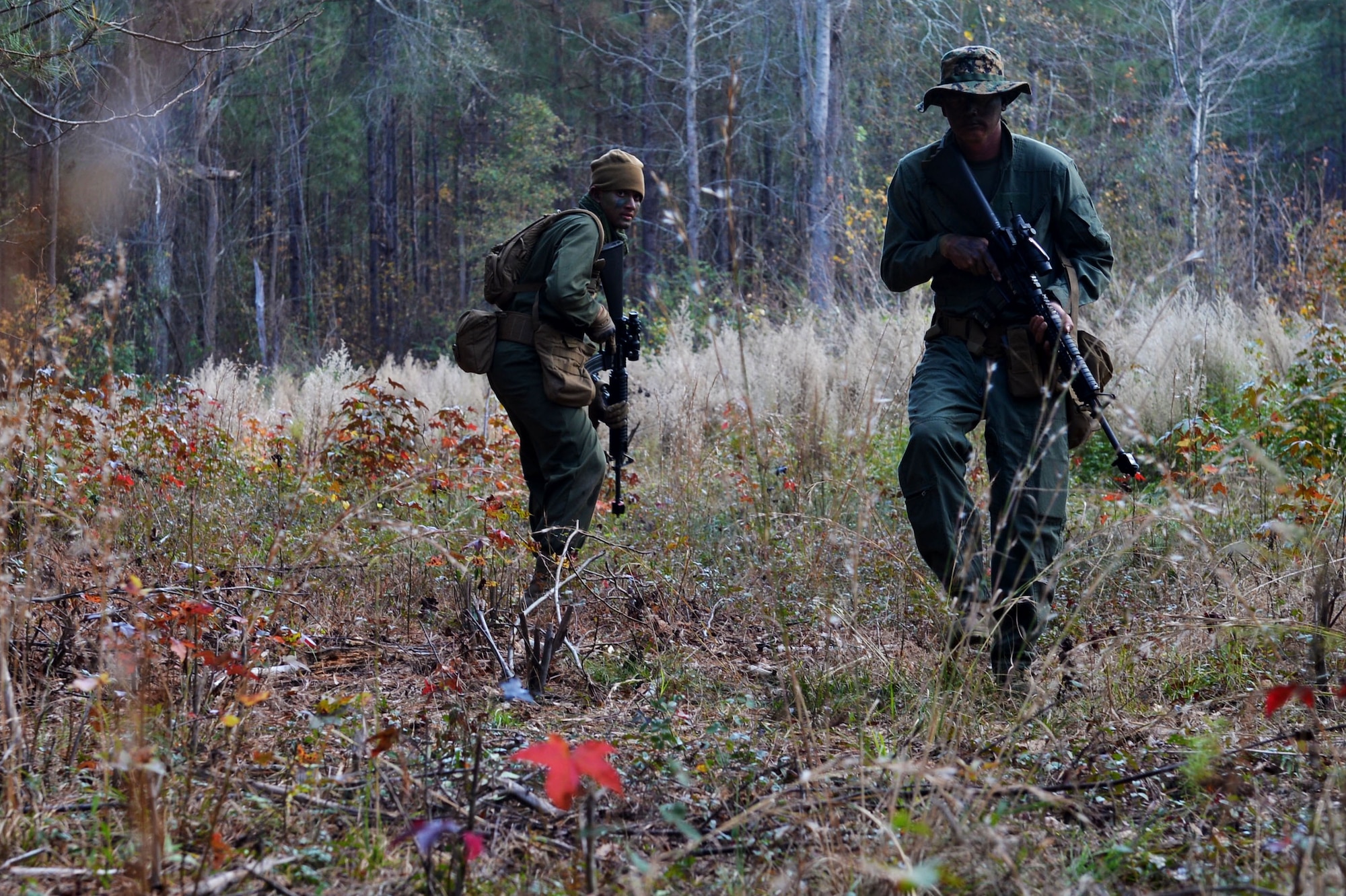 U.S. Marines assigned to Marine Aviation Logistics Squadron 31 stationed at Marine Corps Air Station Beaufort, S.C., trudge through the woods as they make their way to Marine Wing Support Squadron 273’s front lines at Poinsett Electronic Combat Range, Wedgefield, S.C., Dec. 10, 2015. The Marines spent an hour quietly moving through the woods to engage the enemy. (U.S. Air Force photo by Senior Airman Diana Cossaboom)