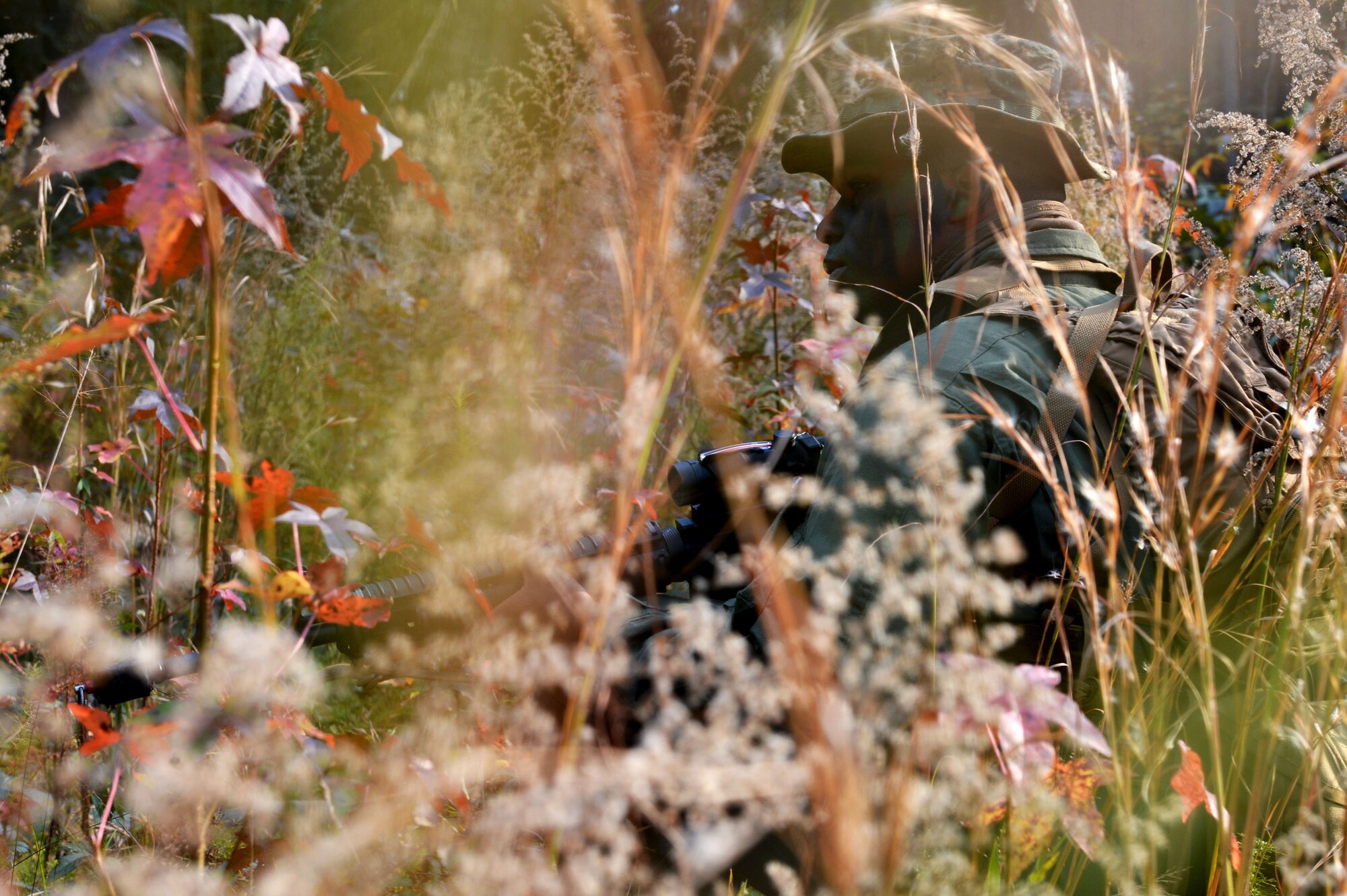A U.S. Marine assigned to Marine Aviation Logistics Squadron 31 stationed at Marine Corps Air Station Beaufort, S.C., takes cover in brush as he waits for an enemy convoy to pass at Poinsett Electronic Combat Range, Wedgefield, S.C., Dec. 10, 2015. Throughout the week, MALS 31 Marines served as a Red Cell team, randomly engaging Marine Wing Support Squadron 273’s security team. (U.S. Air Force photo by Senior Airman Diana Cossaboom)