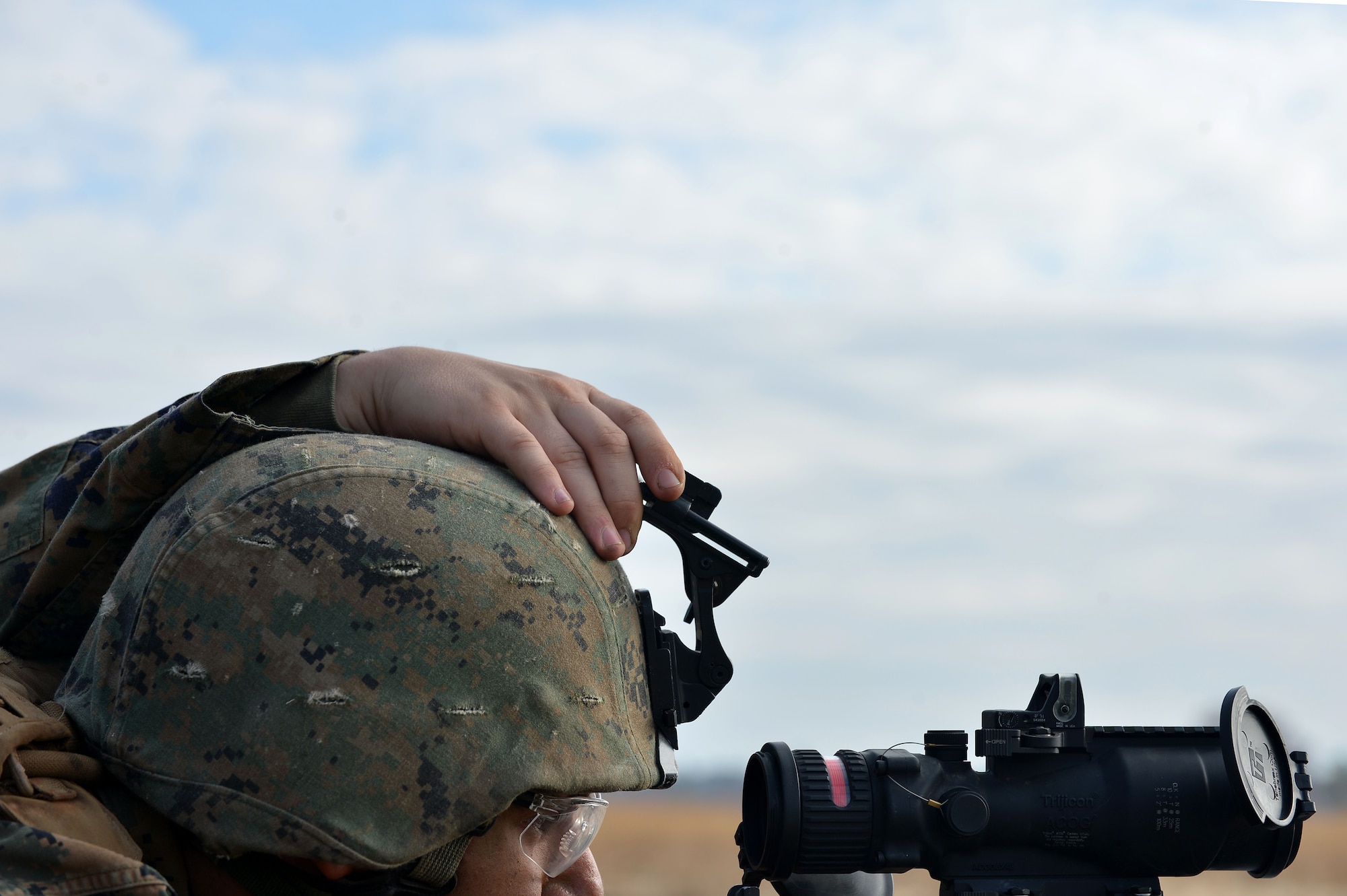A U.S. Marine assigned to Marine Wing Support Squadron 273 stationed at Marine Corps Air Station Beaufort, S.C., looks through the scope of an M240 machine gun at Poinsett Electronic Combat Range, Wedgefield, S.C., Dec. 9, 2015. The Marines spent a week at the range practicing various combat skills they could use in a deployed environment. (U.S. Air Force photo by Senior Airman Michael Cossaboom)