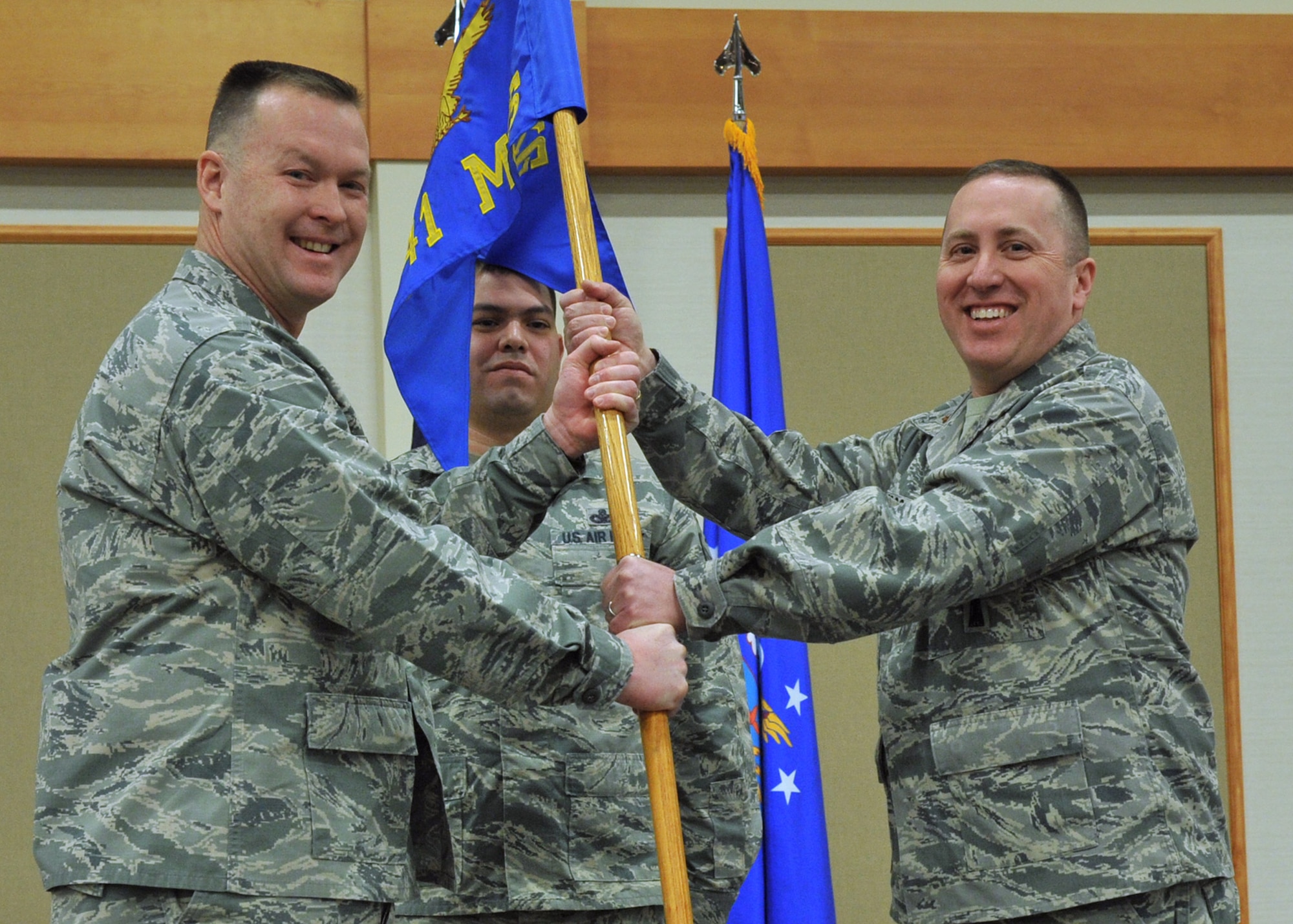 Maj. James Spoo, right, formally accepts command of the 741st Maintenance Squadron from Col. Kenneth Speidel, 341st Maintenance Group commander, left, Dec. 30, 2015 at Malmstrom Air Force Base, Mont. Guidon bearer Master Sgt. Daniel Olivares, 741st MXS first sergeant, center, looks on. The Air Force officially inactivated the 341st Maintenance Operations Squadron at Malmstrom Sept. 30, 2015, and redesignated it the 741st MXS in a move to standardize all maintenance organizations across the force. (U.S. Air Force photo/John Turner) 