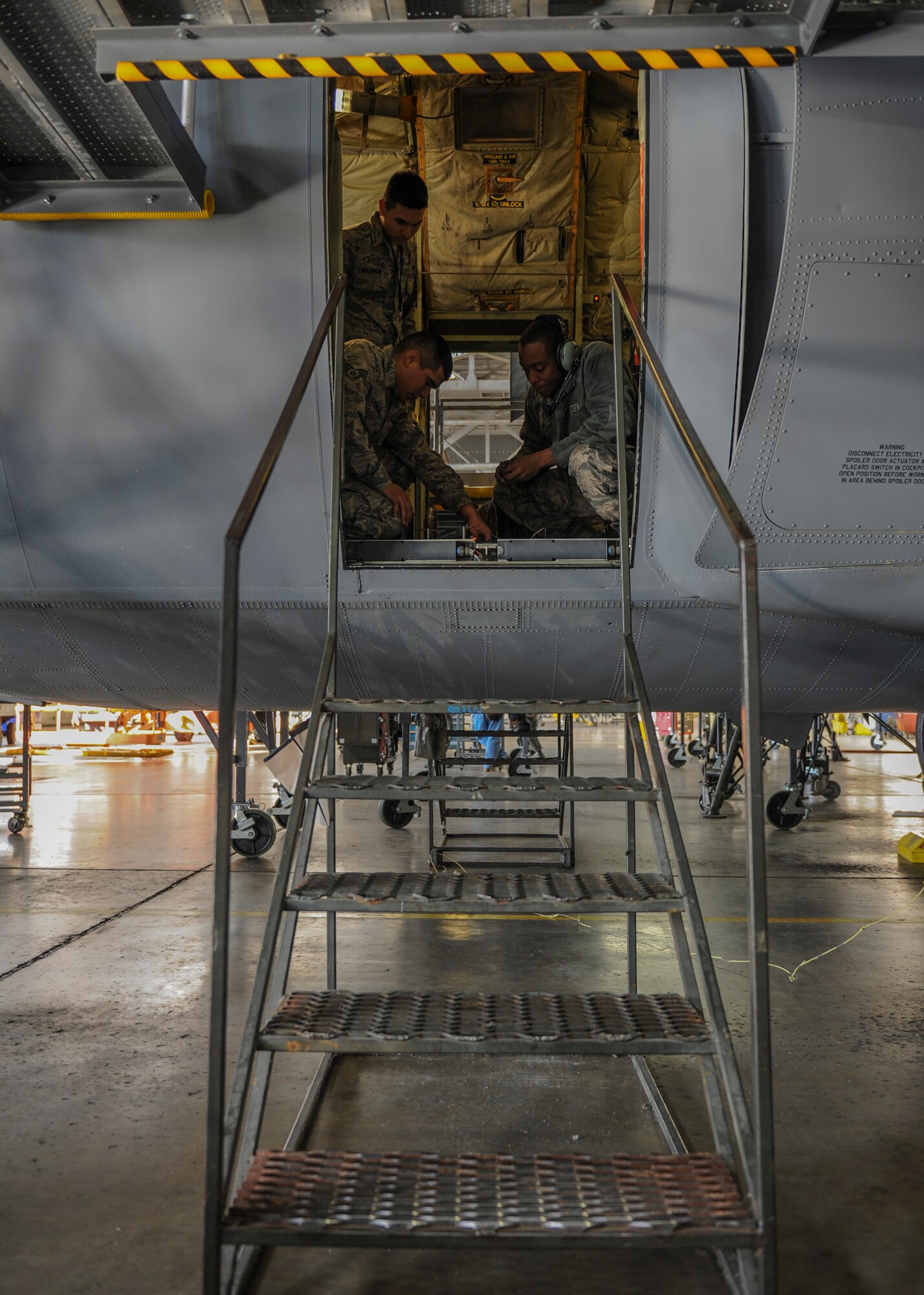 Airmen from the 19th Maintenance Squadron recalibrate ramp locks on a C-130J Jan. 5, 2015, at Little Rock Air Force Base, Ark. Little Rock AFB has the largest facilities in the world designed for C-130 maintenance.  (U.S Air Force photo/Senior Airman Harry Brexel)