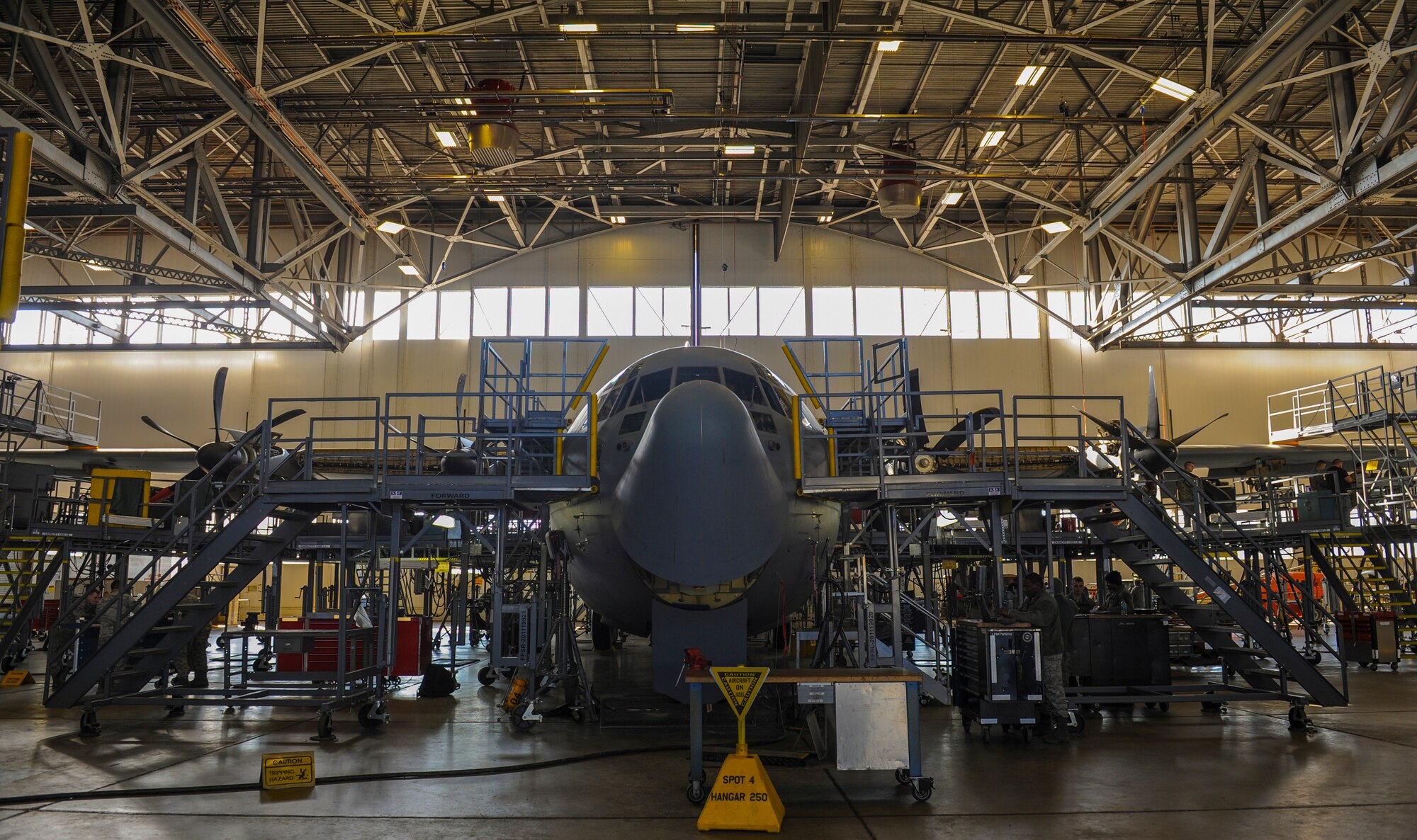 Airmen from the 19th Maintenance Squadron perform an isochronal inspection on a C-130J Jan. 5, 2015, at Little Rock Air Force Base, Ark. Raised stands are placed around aircraft and assembled under the wings and allow multiple mechanics to work on different parts of the aircraft simultaneously. (U.S Air Force photo/Senior Airman Harry Brexel) 