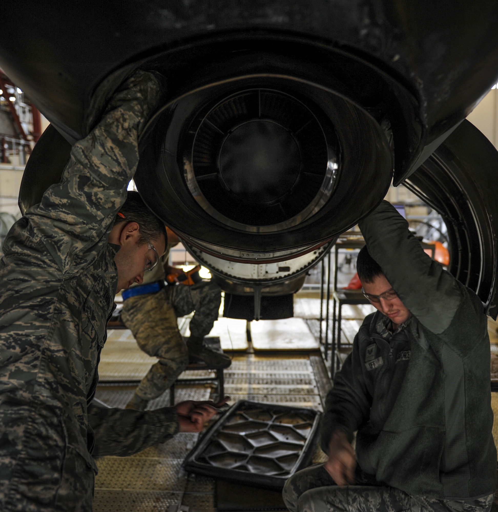 U.S. Air Force Airman 1st Class Hayden Thomas, 19th MXS aerospace propulsion apprentice, left, and Senior Airman Cory Poff, 19th Maintenance Squadron aerospace propulsion journeyman replace a turbine exhaust casing on a C-130J engine Dec. 29, 2015, at Little Rock Air Force Base, Ark. Maintainers from the 19th MXS work on isochronal platforms with electric power, compressed air and lights that allow a large number of people to work on a C-130 at once. (U.S Air Force photo/Senior Airman Harry Brexel)