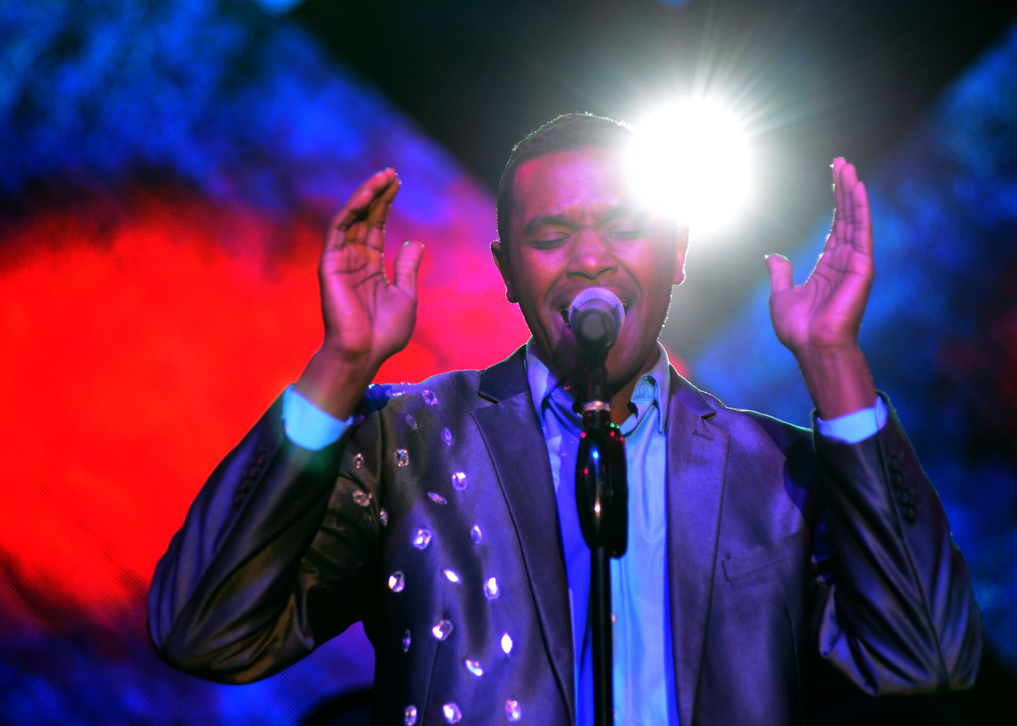 U.S. Air Force Staff Sgt. Sherita Tisdom, Tops in Blue vocalist, performs during a Tops in Blue show, Jan. 4, 2016, at Aviano Air Base, Italy. This year’s tour included songs from several artists, including Ricky Martin, Bruno Mars and Meghan Trainor. (U.S. Air Force photo by Senior Airman Areca T. Bell/Released) 