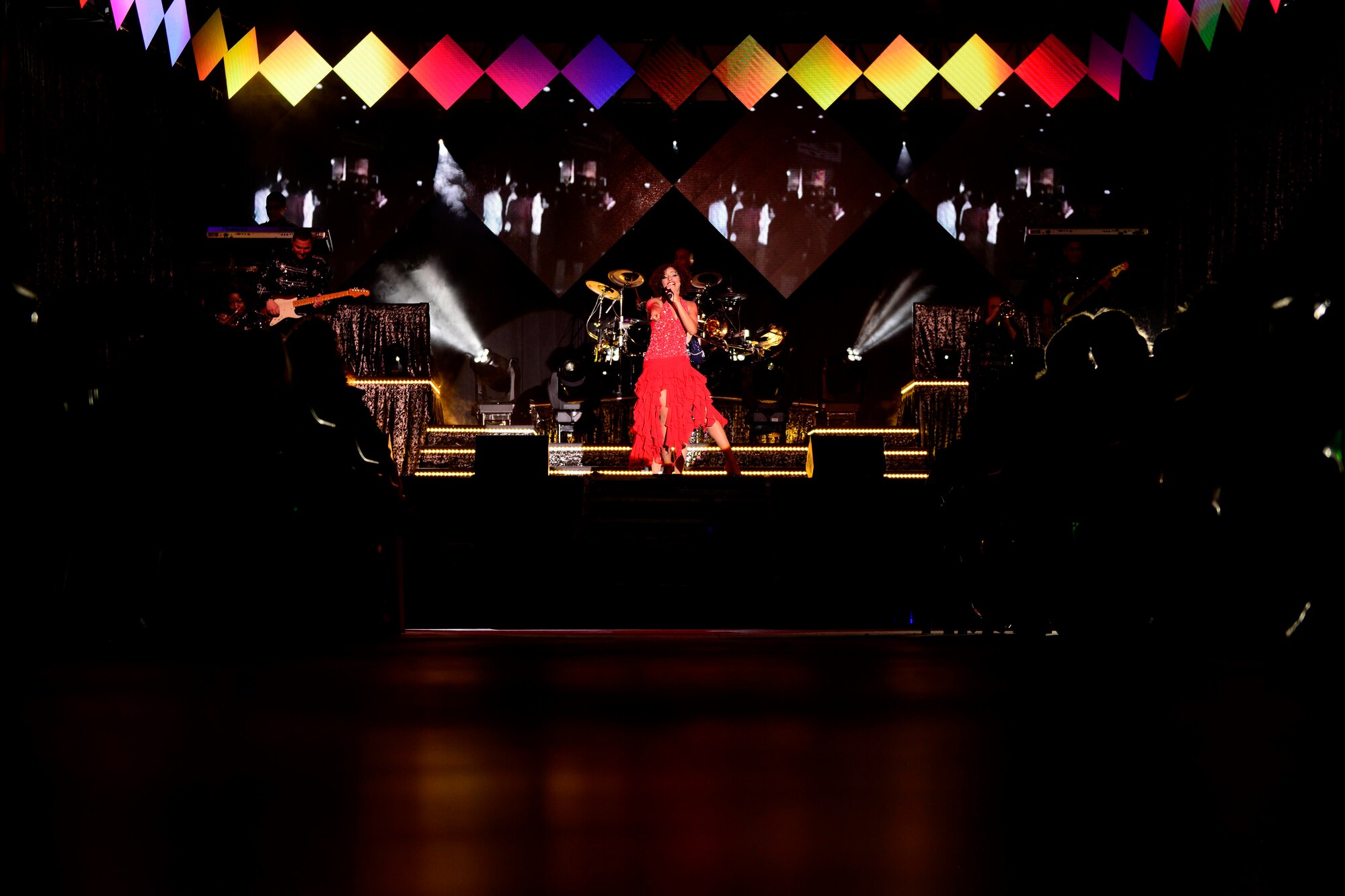 U.S. Air Force 2nd Lt. Nicque Robinson, Tops in Blue flight chief and vocalist, performs during a Tops in Blue show, Jan. 4, 2016, at Aviano Air Base, Italy. Each year, the Expeditionary Entertainment Unit tours both stateside and overseas, to entertain service members, families and local community members. (U.S. Air Force photo by Senior Airman Areca T. Bell/Released)