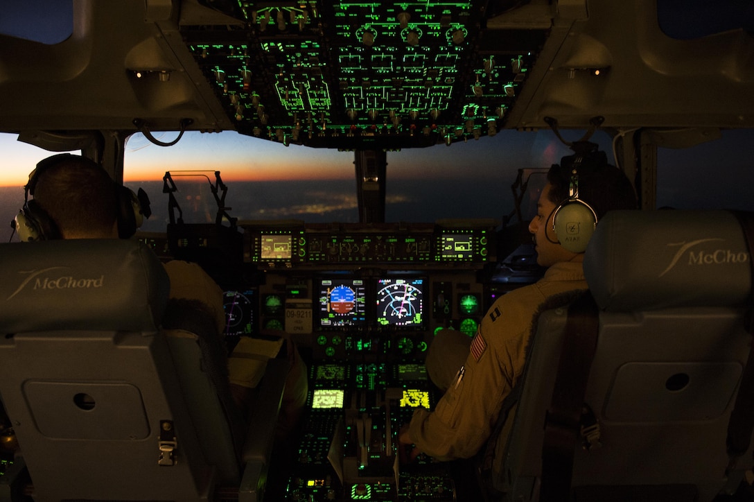 U.S. Air Force 1st Lt. Joshua Moore, left, and Capt. Stephan Azab fly a C-17 Globemaster III aircraft to Incirlik Air Base, Turkey, in support of Operation Inherent Resolve, Dec. 22, 2015. Moore and Azab are pilots assigned to the 816th Expeditionary Airlift Squadron. U.S. Air Force photo by Tech. Sgt. Nathan Lipscomb